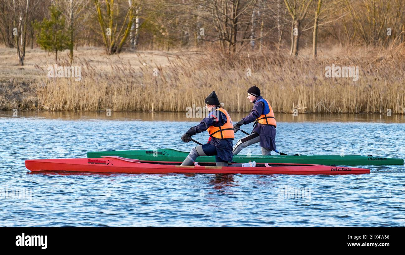 MINSK, BELARUS - MARCH 09, 2022: Two young rowing canoeists trains in open water early spring Stock Photo