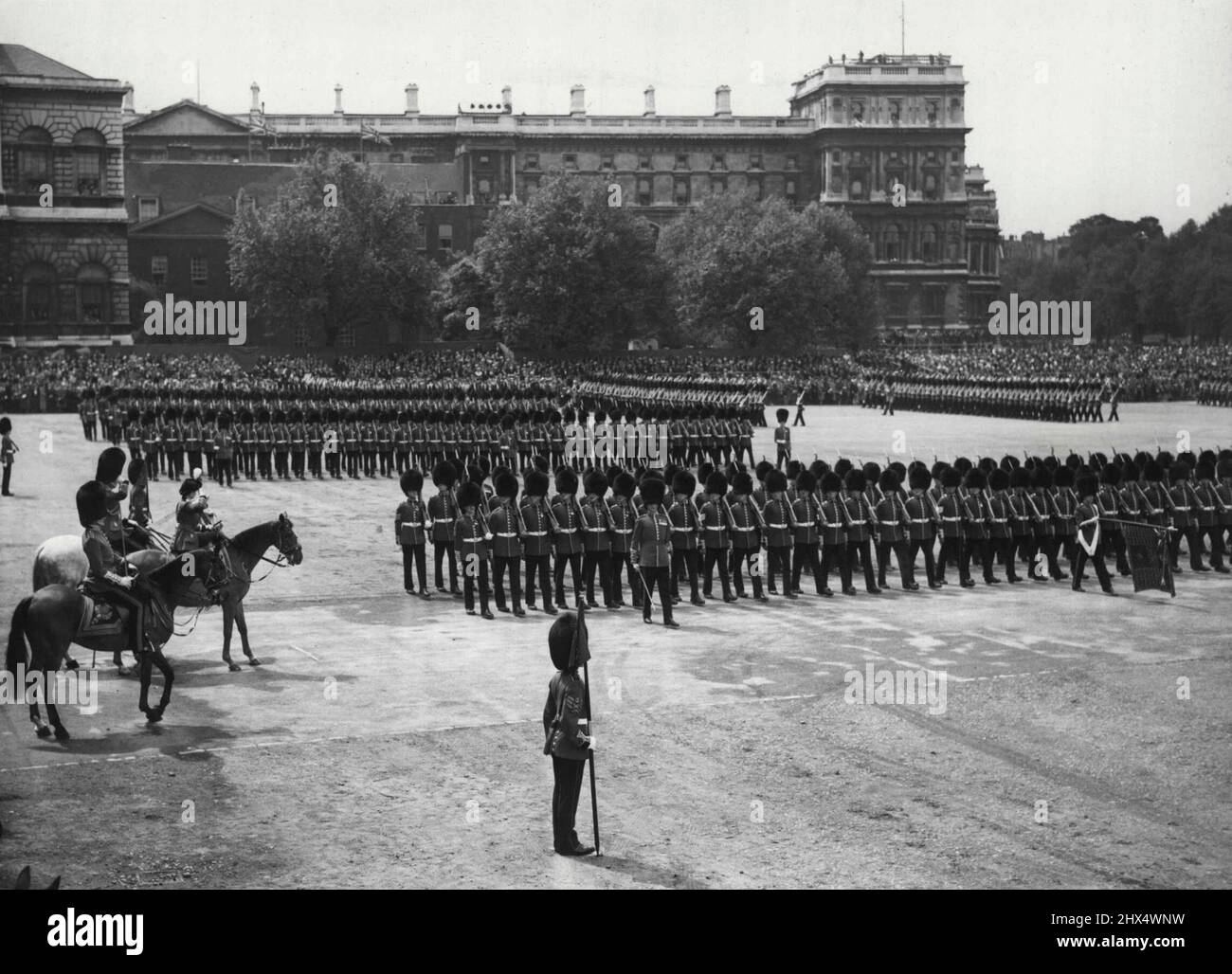 Princess Elizabeth Acts For King In Colourful Trooping Ceremony -- The splendid ceremony of the actual Trooping the Colour (seen right). Princess Elizabeth is on left at the salute She is wearing a plumed hat which is modelled after that of a Guards Officer of 1745. Princess Elizabeth in a colourful Guards-style uniform took the place of the King who is ill, in today's King's Birthday ceremony of Trooping the Colour on Horse Guards Parade, London. The Colour Trooped (i.e. carried in full ceremonial before the Troops) was the King's Colour of the Thire (3rd) Battalion Grenadier Guards (The Prin Stock Photo