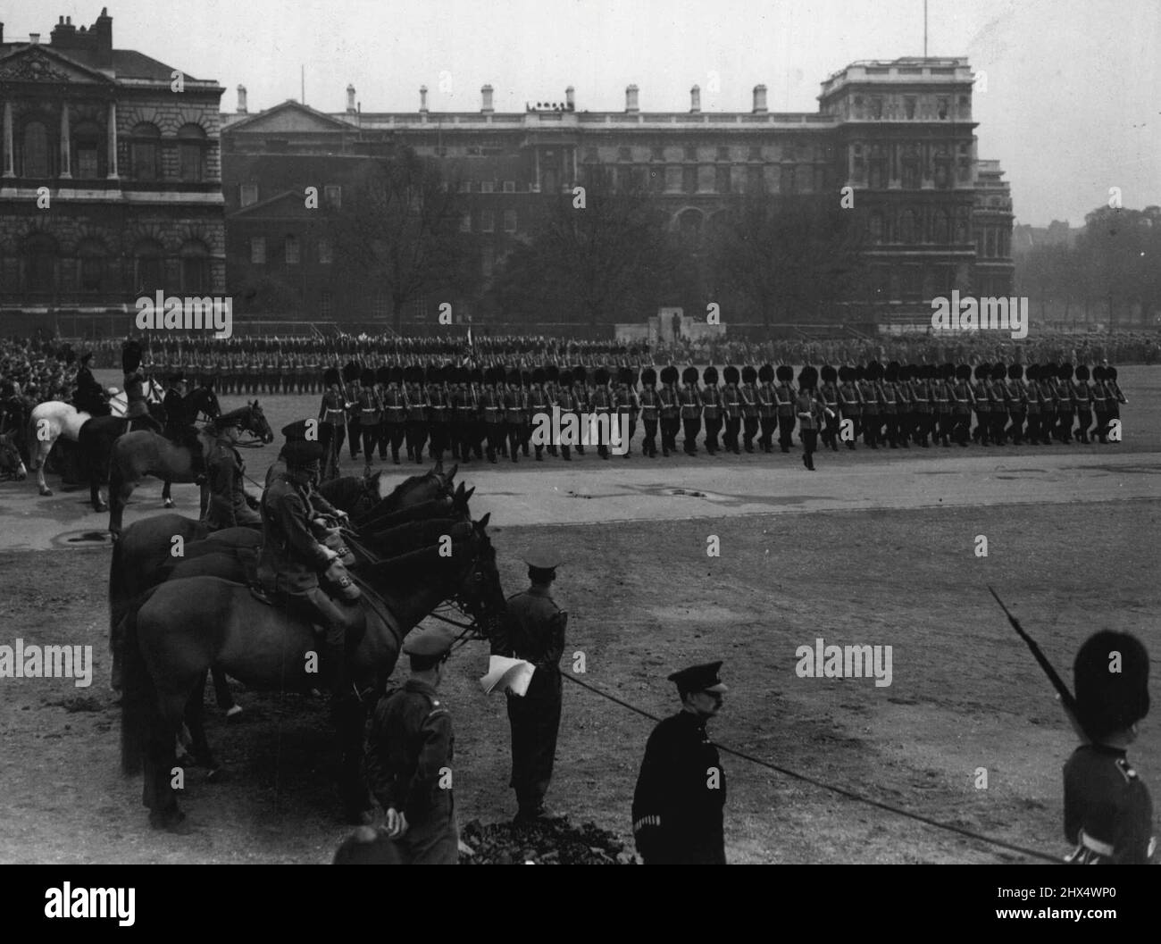 Trooping Rehearsal -- A splash of colour on dull morning when the Coldstrean and Scots Guards rehears e for Trooping the colour ceremony at Horse Guards Parade to-day. Winston, the horse princess Elizabeth will ride at the ceremony on June7, is seen on the left, mounted by Supt. Smith, Metropolitan Police. May 19, 1951. (Photo by Daily Mail Contract Picture). Stock Photo