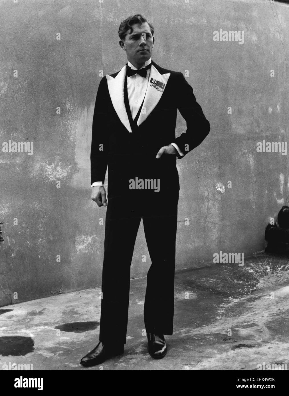 How Should An Officer Dress For Dinner? -- That is the pre-war officers's mess  dress: Scarlet monkey jacket, waistcoat, starched shirt, black bow tie,  tight striped blue trousers with straps going under