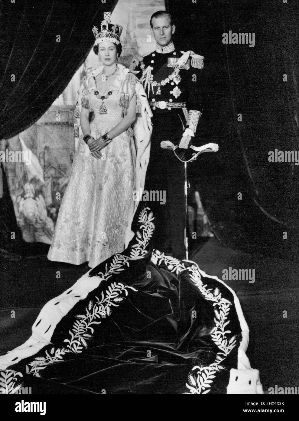 United In Resolve - Her Majesty Queen Elizabeth II with her husband, the Duke of Edinburgh, photographed in the Throne room of Buckingham Palace just after the coronation. In her speech to the nation on June 2nd, her majesty said; 'All My Life...! shall strive to be worthy of four trust, in this resolve I have my husband to support me. He shares all my ideas and all my affection for you.' June 07, 1953. (Photo by Paul Popper). Stock Photo