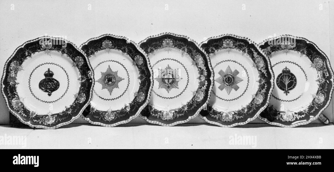 Guards Present To Princess -- Part of the Service ordered by the Brigade of Guards. Every piece bears a regimental badge. Those on these plates are (Left to right) Grenadier, Irish, Coldstream. Scots and Welsh Guards. An Imperial red and gold dessert, Service has been ordered by the Brigade of Guards as a weeding present for Princess Elizabeth, and is being made at Worcester by the Royal Porcelain Company. It is one of the four China services being made as wedding presents for the brigade of Guards (2) the City of Worcester and the Worshipful Company of Carpenters, none of which will be ready Stock Photo