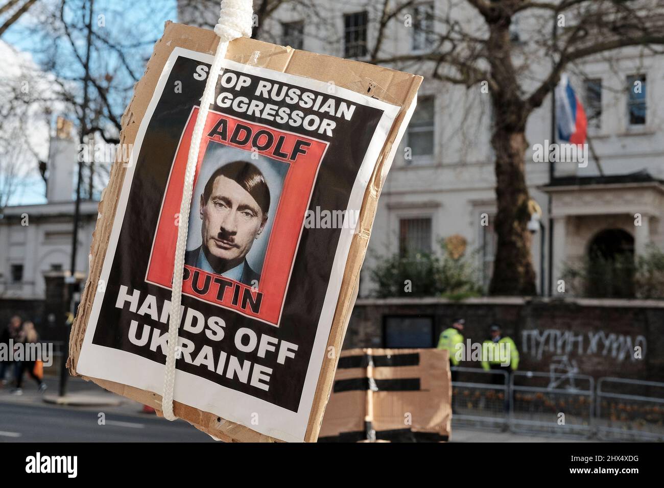 London UK, 9th March 2022.  An image of Vladimir Putin depicted as Adolf Hitler swings from a makeshift gibbet opposite the Russian Embassy. Stock Photo