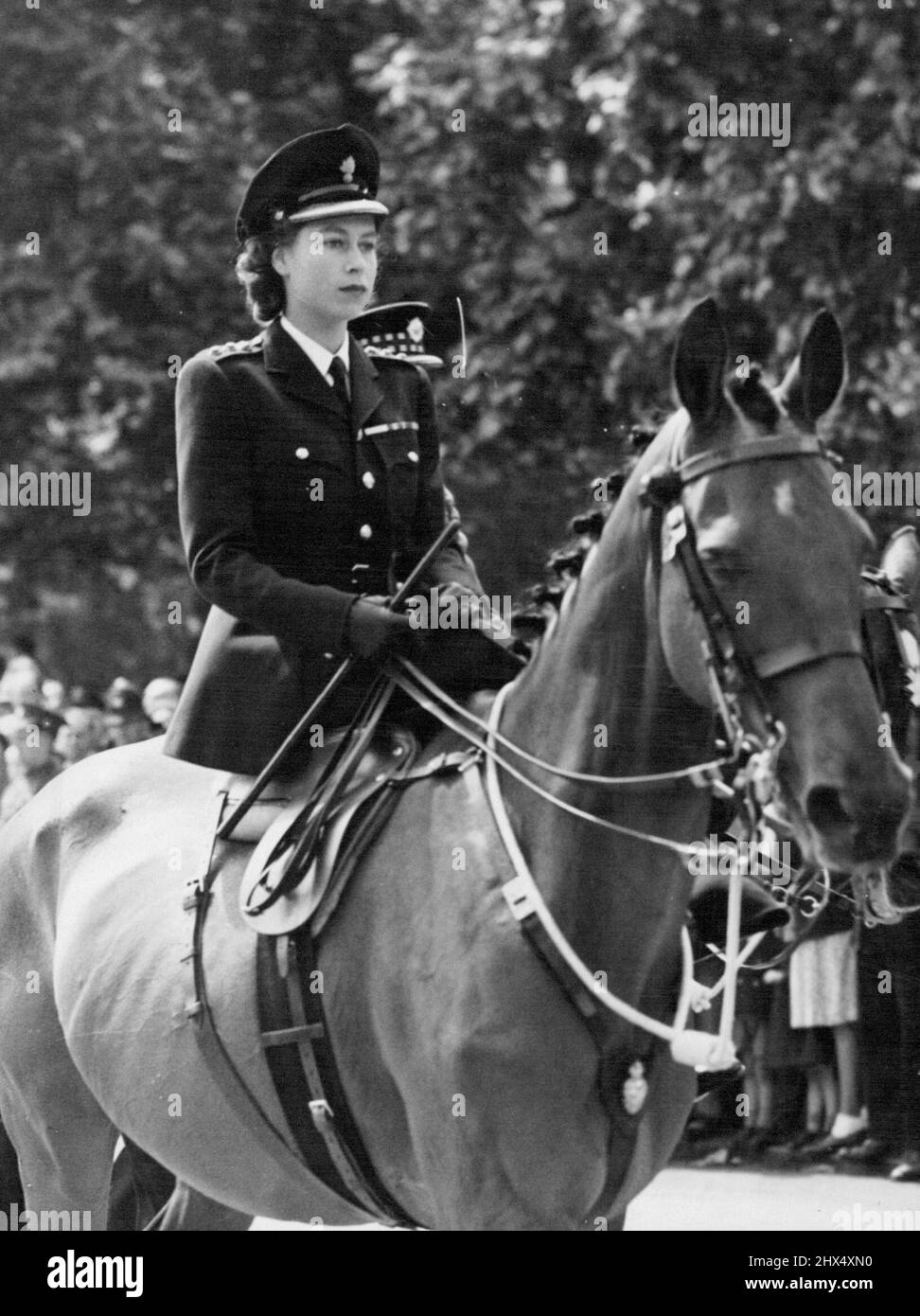 Trooping The Colour Ceremony - H.R.H. Princess Elizabeth made a striking figure a she rode side-saddle in her new uniform. The annual ceremony of Trooping the Colour was held today, the official birthday of the King. The ceremony took place at the Horse Guards parade, Whitehall, London. The King was accompanied by Princess Elizabeth who rode side-saddle on her mount. June 12, 1947. (Photo by Fox Photos). Stock Photo