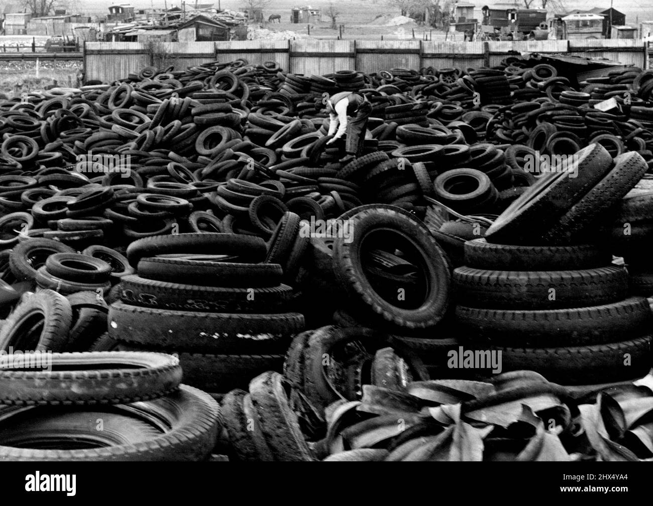 Rolling In The Rubber -- One of the rubber dumps in the South of England. Into every modern fighting machine there goes pounds of rubber and with our chain supplies so disastrously reduced the only way in which the Nation can meet the demand is by scrupulously Salvaging every scrap of rubber available. One of the chief sources of supply is the collection of worn tires for which many dumps have been instituted all over the country. April 22, 1942. (Photo by Fox Photo). Stock Photo