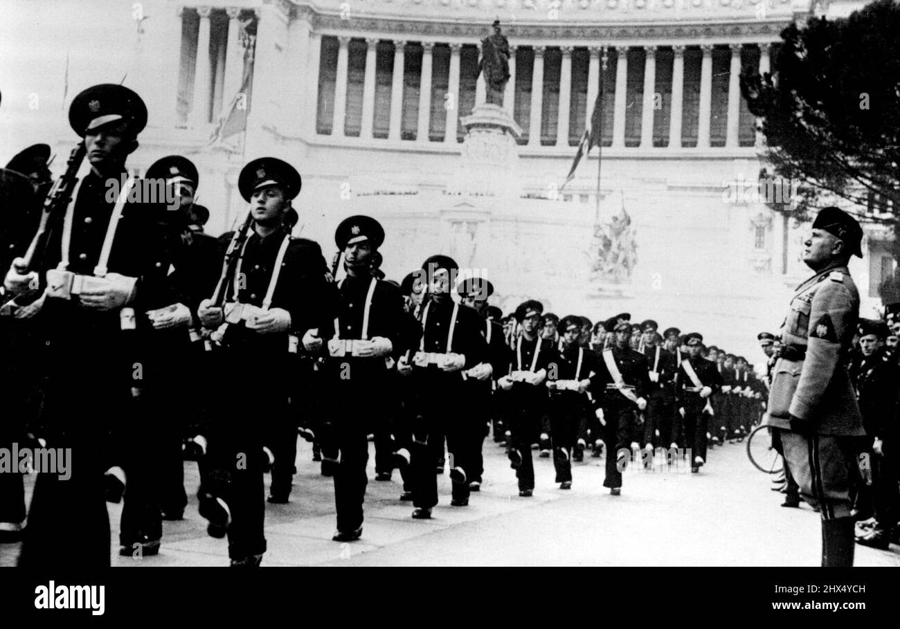 19th Anniversary Of Foundation Of Fascism. Signor Mussolini Photographed in the Piazza Venezia, watching the march past of students of the Rome military school, doing the 'Roman Step' the Italian version of the German goose step. The occasion was the nineteenth anniversary of the foundation of Fascism. In the background is the unknown Warrior's toms. March 25, 1938. (Photo by Keystone) Stock Photo