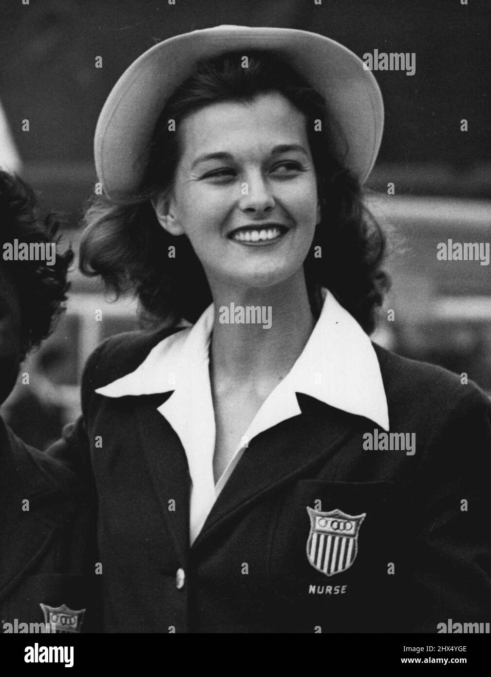 'Picture Of Health' Nurse Comes With Olympic Team: Smiling Nurse Dorothy Whitley, has arrived with the U.S. Olympic team, aboard the S.S. America, at Southampton, to-day (Wednesday). Charged with guarding the health of her athletic charges, Dorothy makes sickness 'almost a pleasure'. Her team says 'What a nurse'. She comes from Washington, D.C. July 21, 1948. (Photo by Reuterphoto) Stock Photo
