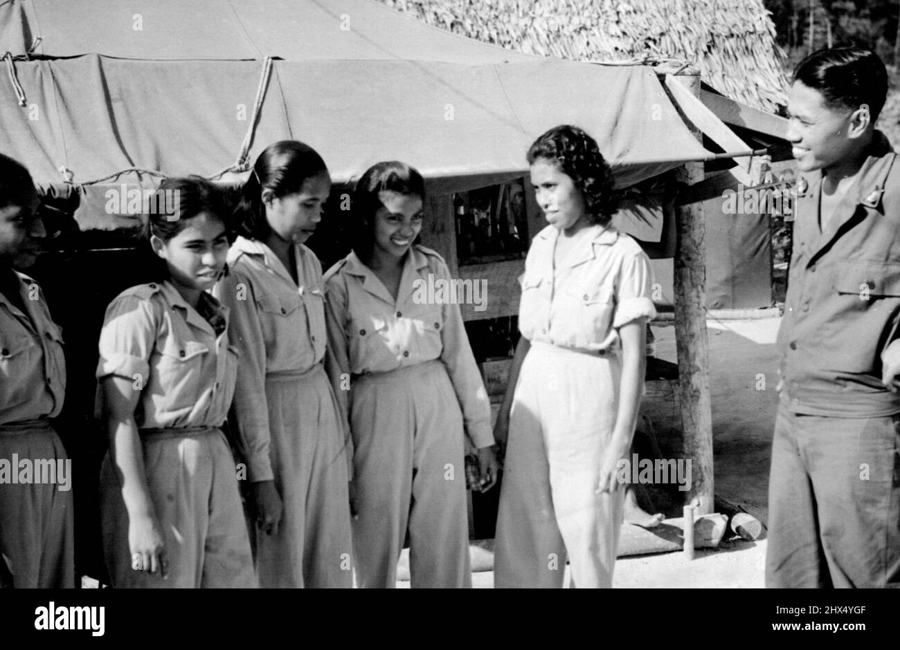 Lieutenant Abdeeravai. Medical Officer at NICA Netherlands Indies Civil Administration Hospital on Biak Island, Netherlands New Guinea with members of his staff. Evacuated from Japan Island, Indonesian women volunteered as nurses and have proved their capability in all branches of Hospital work. April 23, 1945. (Photo by Netherlands Indies Government Information Service). Stock Photo