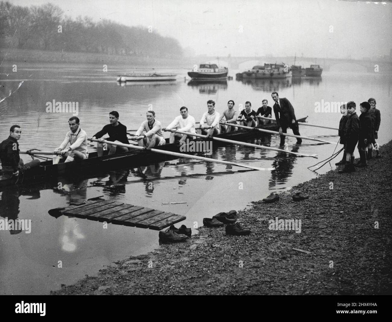 Australian Oarsmen in England, who are hoping to form an eight to represent Australia in Olympic Games, have been holding trials on the Thames. Several combinations have been tried from amongst the twenty-three oarsmen so far available.Here one of the combinations shown, using a practice shell borrowed from the Thames rowing club, Putney.The crew is : Bow Graham Fisk (Sydney), 2 Brian Lloyd (Sydney), Colin Smith (Sydney), 4 Bill Lester, 5 Dr. James Guest OBE, (Melbourne), 6 Dr. William Woodward (Sydney), 7 Larry Foley (Sydney), Stroke Gordon Hill (Perth), Cox Peter Lawrence. January 01, 1948. Stock Photo