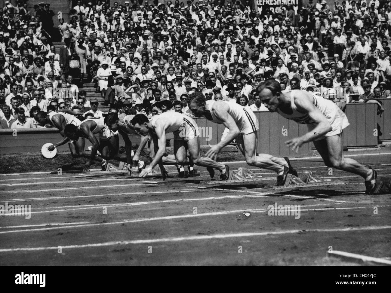 Olympic Games: The start of heat 1 Semi-Finals of the 100 metres, at Wembley, to-day (Sat). Left to Right : H. Ewell (USA), H. Dillard (USA) J. J. Lopez Teste (Uruguay), M.J. Curotta (Australia) J. M. Bartram (Australia), and A. MacCorquodale (Britain). July 31, 1948. (Photo by Reuterphoto). Stock Photo