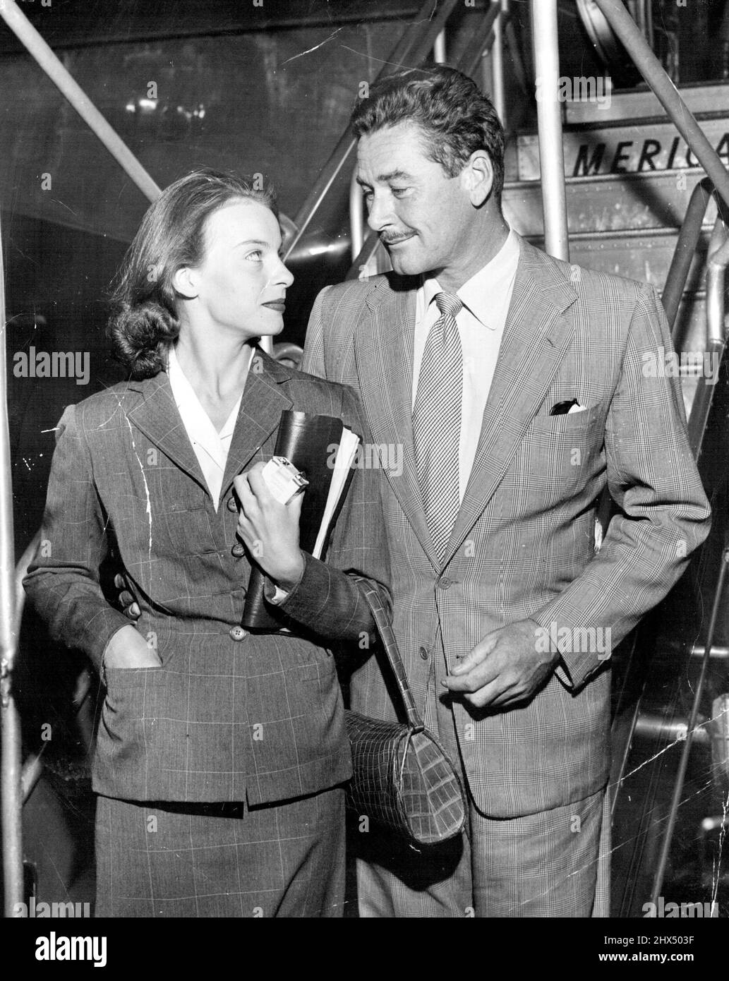 Errol Flynn, looking a little tireder than the fans know him, arrives in Hollywood with his Princess Ghika. July 09, 1950. Stock Photo