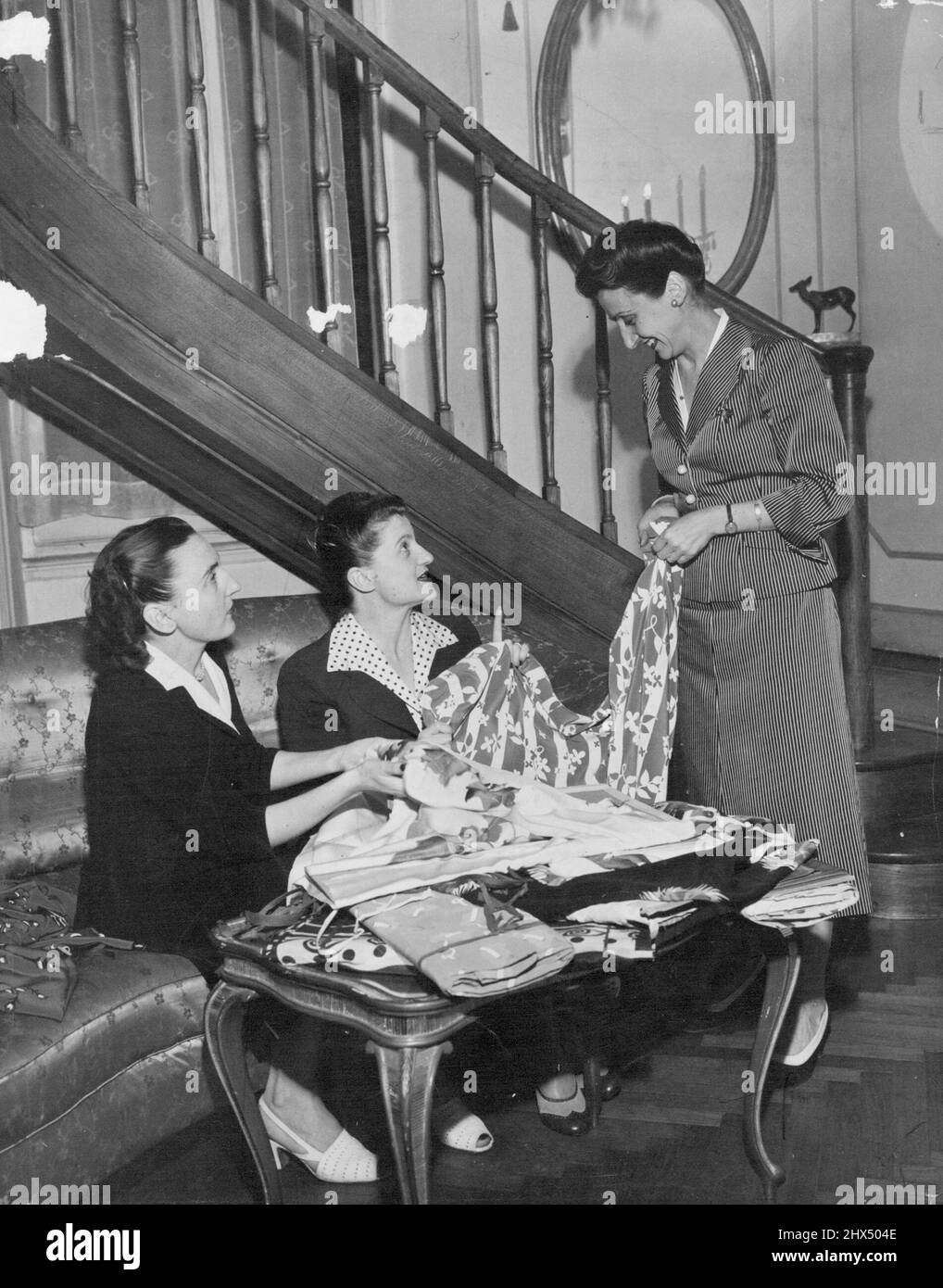 The Sister Fontana - Micol, Zoe, Giovanna - inspecting new fabrics. Most of them of woven exclusively for the Salon Fontana. September 29, 1952. (Photo by The Associated Press) Stock Photo