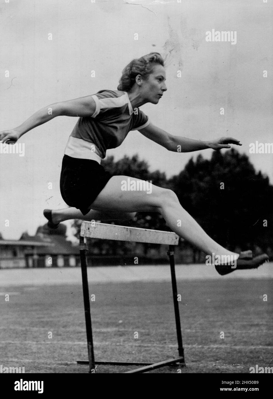 Australian Girl Hurdles To Helsinki Via London -- Miss Shirley Strickland (Western Australia), one of Australia's women athletes for the Olympic Games, practising over the hurdles at Paddington Track, London, today (Thursday). The Australian athletes are in London on their way to Helsinki. Miss Strickland is a 100 and 200-metres sprinter as well as a hurdler. June 19, 1952. (Photo by Reuterphoto). Stock Photo