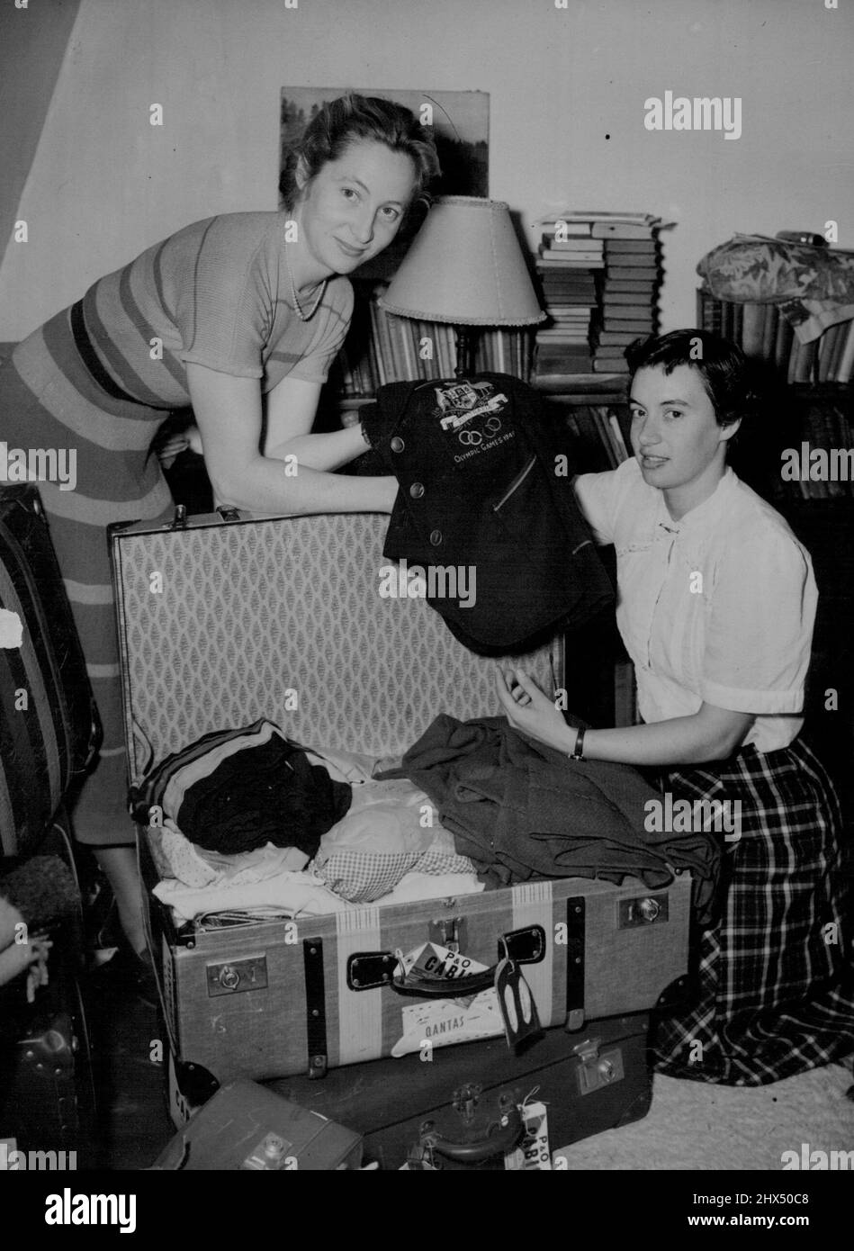 Australian Olympic Girls Get Ready To Leave -- Two of Australia's Olympic Games athletes-sprinter, hurdler and Olympic Gold Medal winner Shirley Strickland (left) and long jumper Verna Johnson-putting the finishing touches to their packing in London today (Tuesday) before leaving later in the day on the homeward journey to Australia. October 07, 1952. (Photo by Reuterphoto). Stock Photo