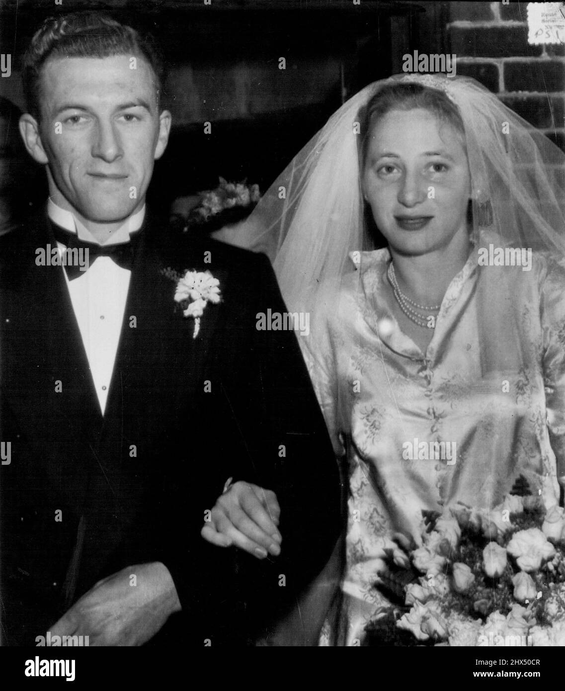 Shirley Strickland and husband Laurence Delahunty leave St. Matthews Church, Guildford, after wedding, June 1. West At Wedding -- Shirley Strickland, Olympic hurdler, and her husband, Laurence Delahunty, leaving Guildford Anglican Church, Perth, after their wedding last night. Miss Strickland broke down and wept when she arrived at the church door. June 02, 1950. (Photo by Daily News). Stock Photo