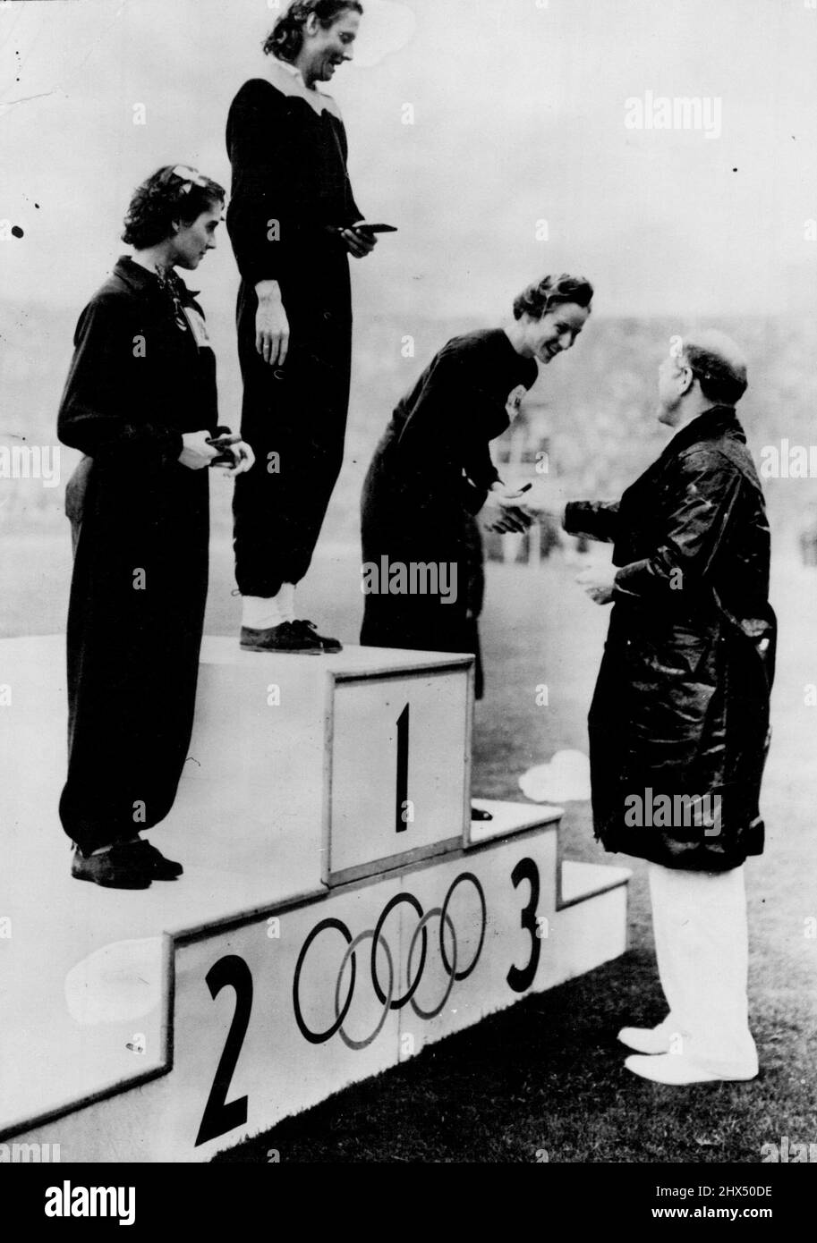 Awards In The Rain -- Standing on the victor's rostrum in the soaking ...