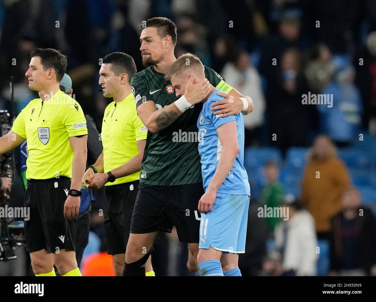 Manchester, England, 9th March 2022.   Sebastian Coates of Sporting Lisbon hugs Oleksandr Zinchenko of Manchester City during the UEFA Champions League match at the Etihad Stadium, Manchester. Picture credit should read: Andrew Yates / Sportimage Stock Photo