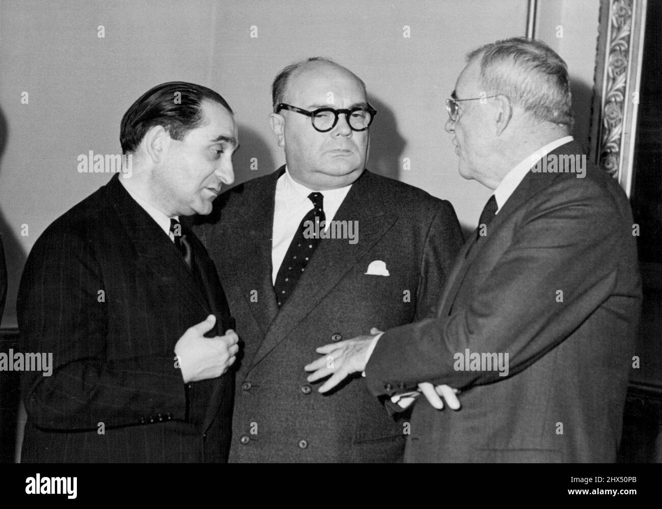 The historic pact making Germany an equal partner in Western defence has been signed, but France's M. Mendes-France (left), Belgium's M. Spaak (center) and America's Mr. Dulles still debate a point. Perhaps it is a last-minute doubt that solemn-looking M. Mendes-France has. But Mr. Dulles seems to be making his point M. Spaak has that Yes-you-have-something-there' look. October 4, 1954. (Photo by Daily Mirror) Stock Photo