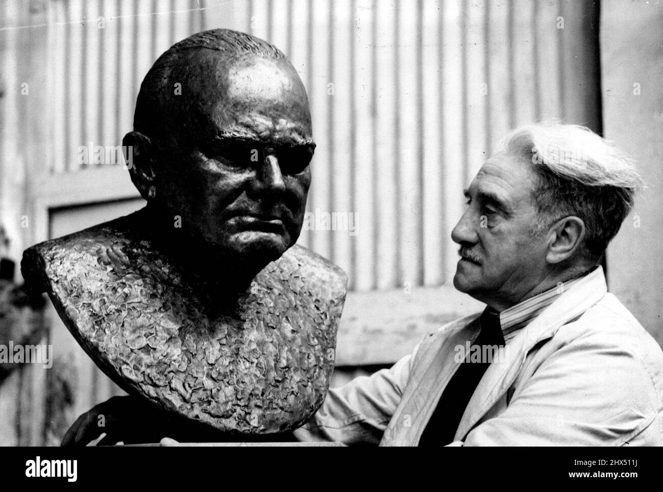 Almost A State Secret -- Benno Elkan at work on his 'secret' bust of Winston Churchill. Mr. Churchill is a hard man to persuade against his will, but Mrs. Churchill did it and the result of her efforts will be seen next January in the Wildenstein Gallery, London, when a bronze bust of the great war-time leader is shown publicly. The bust, a personal tribute to Churchill, has been seven years in the making for most of that time without the knowledge of Mrs. Churchill or her husband. November 29, 1949. (Photo by Reuterphoto). Stock Photo
