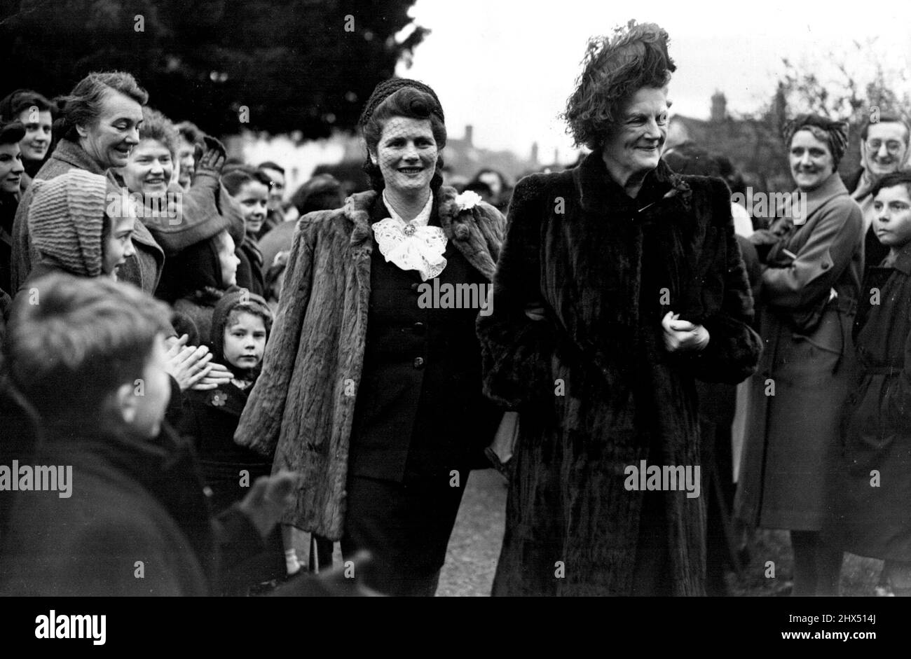 Lord Woolton's Son WedsMiss Mary Churchill, whose engagement to Capt. Christopher Soames was announced yesterday, gets a big hand from sight-seers as she arrives with her mother for the wedding at Beaconsfield to-day (Saturday). At the church of St. Mary and all saints, Beaconsfield, Bucksm this afternoon (Saturday), the Hon. Roger David Marquis, son and heir of Lord Woolton, was married to the Hon. Lucia Lanson,Only daughter of Major General Lord Burnham, of Hll Barn, Beaconsfield. The Bridgeroom's father is a former Minister of food and minister of Reconstruction, and was recently appointed Stock Photo