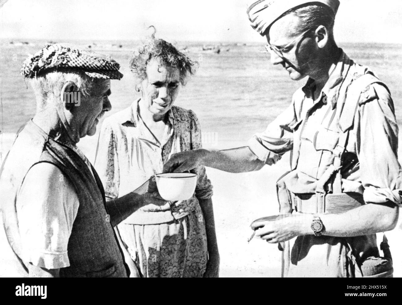 Allied Officer Takes Tea With Italian Residents An Allied officer accepts a mug of tea form residents of Reggio Calabria shortly after the arrival of the British Eighth Army on the Italian mainland. Reggio the Allied forces after their crossing of the strait of Messina form Sicily. November 01, 1943. (Photo by U.S Office Of War Information Picture). Stock Photo