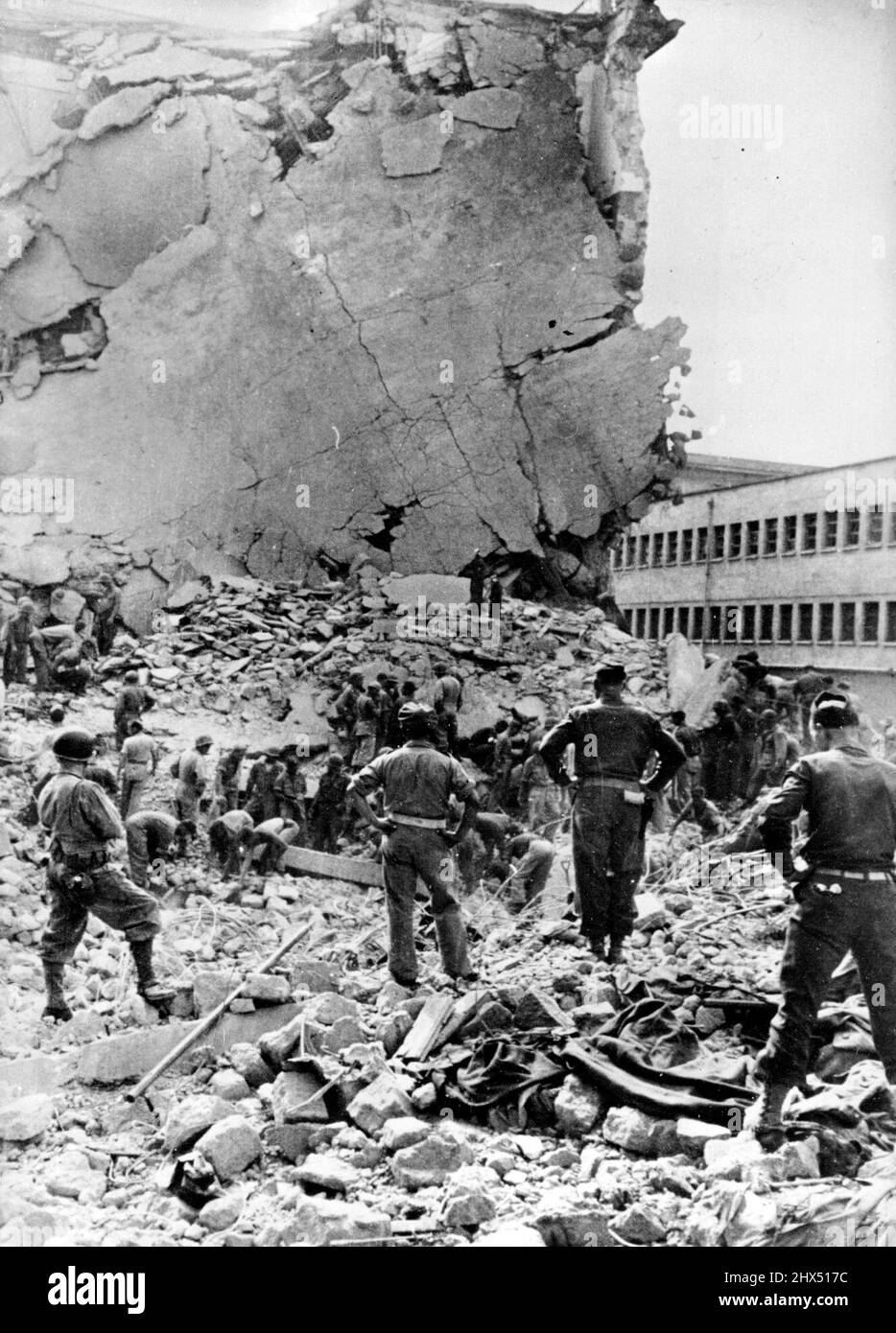 Hidden German Bombs Blast Naples Soldiers of the Allied fifth Army search for bodies amid the ruins of building in Naples, Italy, which was destroyed by a hidden German time bomb. The Germans concealed scores of bombs, timed to explode after they had retreated. One bomb exploded in the Naples Post Office while it was crowded with civilians and killed about 100 persons. December 13, 1943. (Photo by U.S. Office Of War Information Picture). Stock Photo