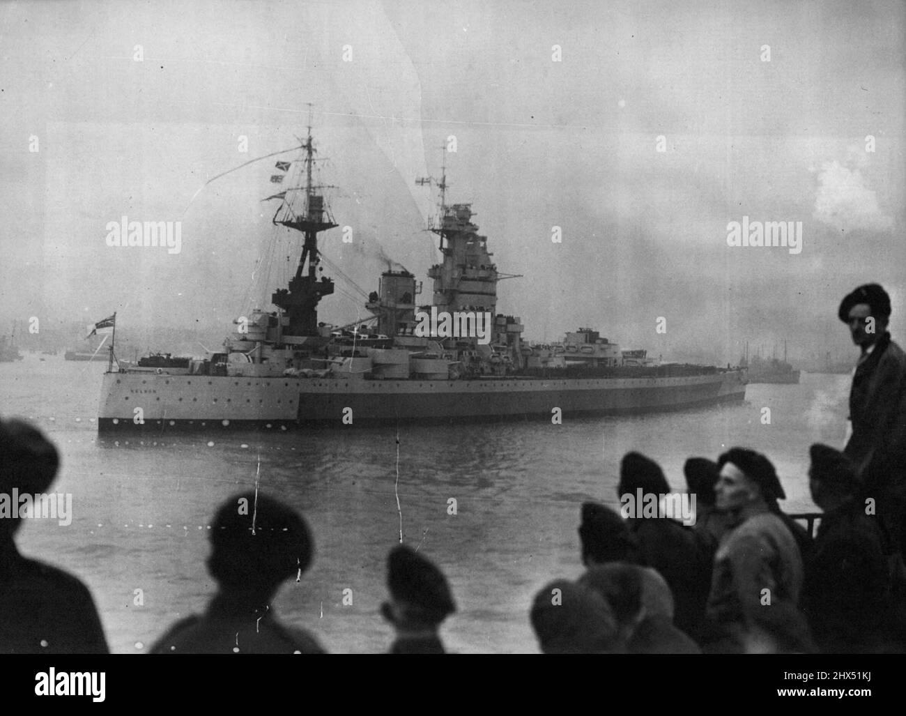 The 'Nelson' Comes Home - Her War Service Over -- H.M.S. Nelson entering Portsmouth Harbour at the end of her long voyageBritain's 16-inch-gun battleship 'Nelson' ended her war service when She arrived in Portsmouth Horbour after an 8,076 miles' voyage from Singapore. In addition to her complement of 1,361 officers and ratings. She has brought home more than 600 army and navy repatriated service menTwo surrenders were signed aboard the 'Nelson' The first was at Malta, where, on September 30th, General Eisenhower. General Alexander and Admiral Sir John Cunningham met to receive from marshal Bad Stock Photo