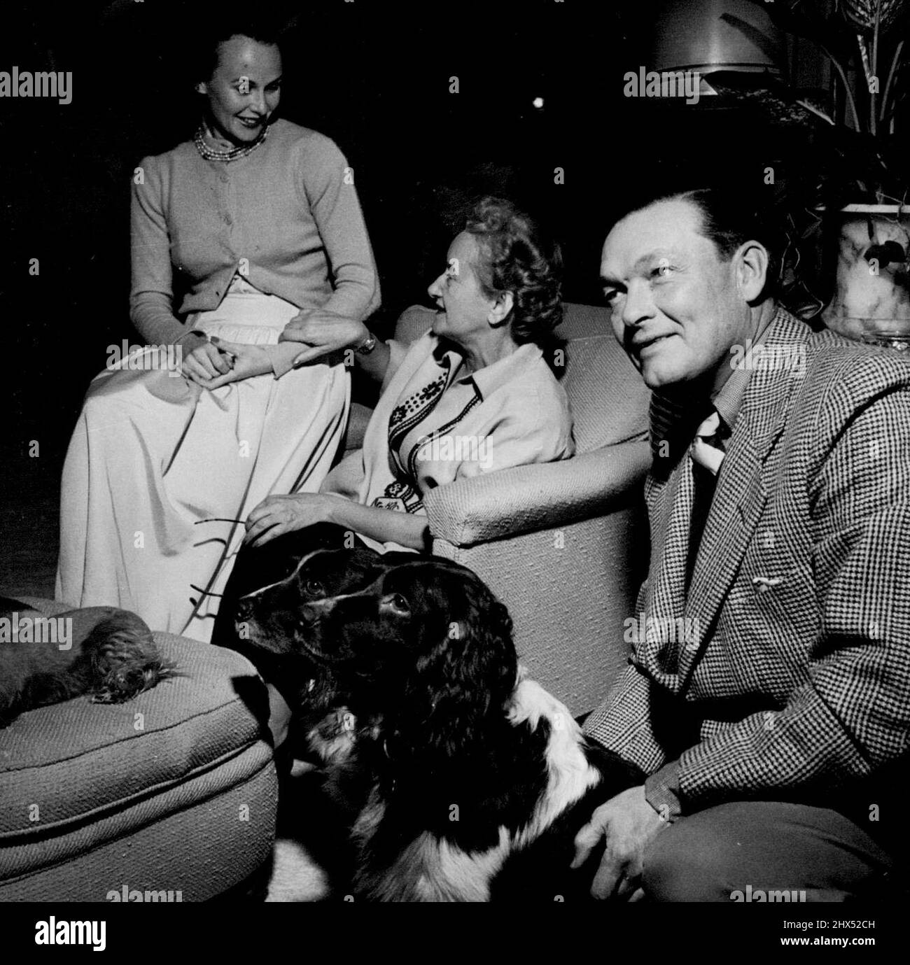 Austine argues about 'the new look' with Hattie Carnegie, while 'Laddie' Sanford discusses his ***** and the breeding of Springer spaniels. March 10, 1948. Stock Photo