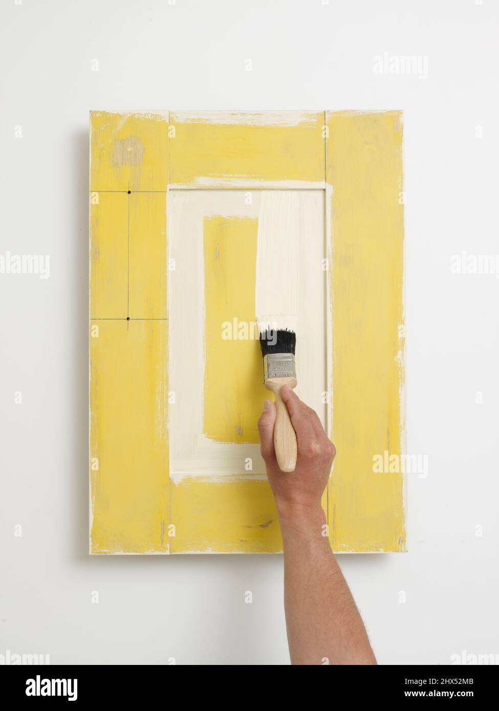Repainting a kitchen unit, painting a door Stock Photo Alamy