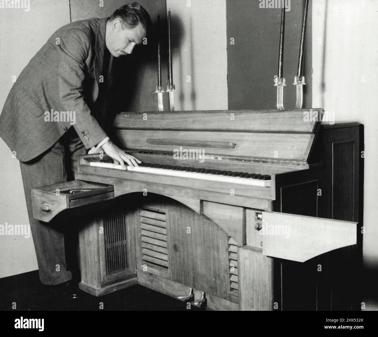 The Dynatone - It Possesses full 88 notes of grand of grand piano. Key-board  is of standard height. Drawer on left houses phonograph turntables. On  right is radio loud-speakers are mounted begin