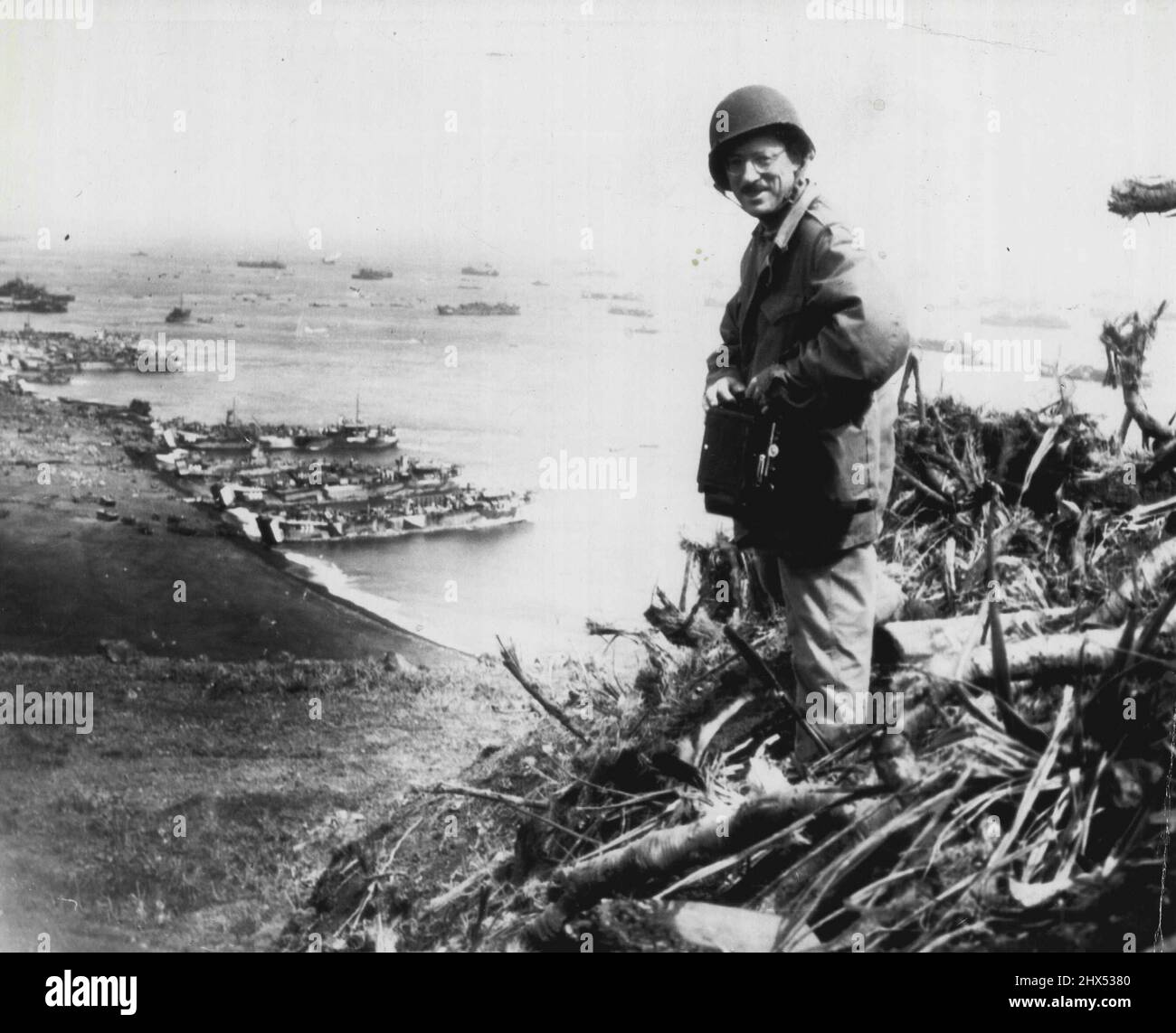 Rosenthal Covers Iwo Landing -- Joe Rosenthal, of the Associated Press, Photographer with the wartime still picture pool, looks over the scene at Iwo Jima, from which he has sent some of the most Graphic Pictures of the Pacific war. Today, in a by-Lined story he tells of events leading up to the Picture of A group of Marines Planting the U.S. Flag a top Mt. Suribachi. March 07, 1945. (Photo by AP Wirephoto). Stock Photo