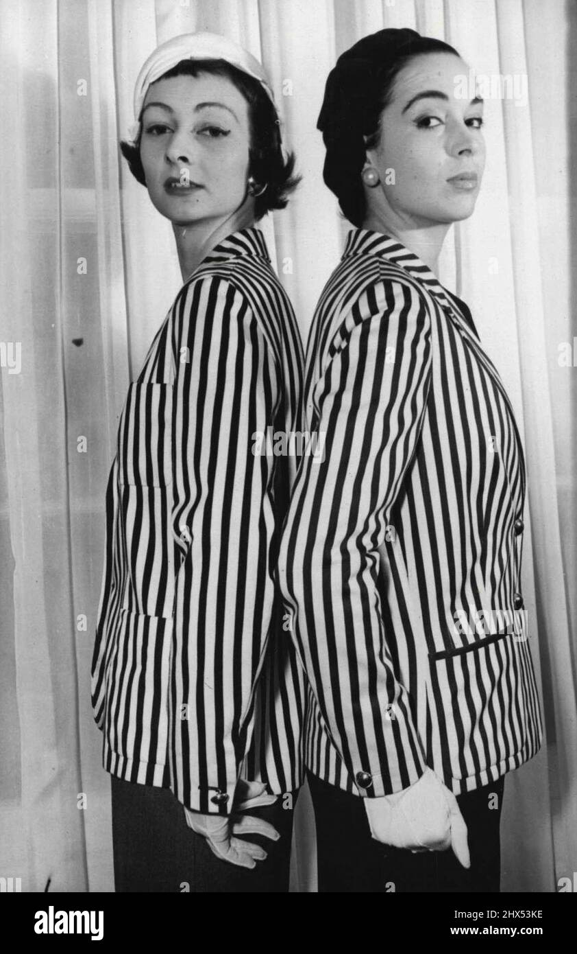 London's Designers Show Their Spring Collections -- A novel effect from Digby Morton, of London. Blazers, casually tailored in boldly striped material, can be worn in town or country, and a change from the conventional jacket. These are in a striking navy-blue and white stripes, over a slim navy dress. February 23, 1955. (Photo by Sports & General Press Agency Limited). Stock Photo