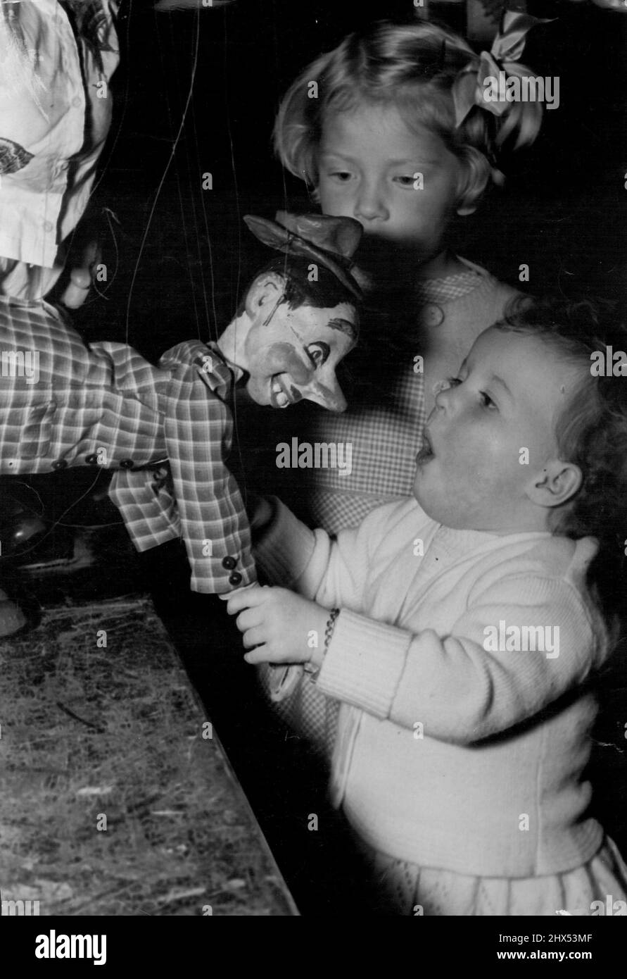 'Oh, My! What a big nose you have!' 18-month-old Karen Cuerdale, of Enmore, gets friendly with one of Peter Scriven's puppets as Jane McCormack, 2, of Glebe Rt., looks on. Jane McCormack, 2, of Glebe Rt. and Karen Cuerdale, 18 months of Enmore watch Peter ***** puppets in a Day in puppet town at a with stone. September 01, 1955. Stock Photo