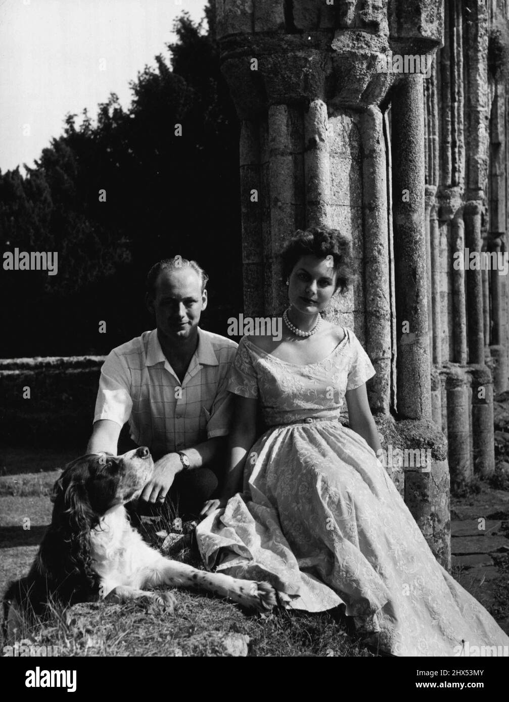 Lord Montagu Of Beaulieu With His Fiancee Miss Ann Gage -- Edward John Barrington Douglas-Scott-Montagu, 3rd Baron Montagu of Beaulieu, photographed with his fiancee, Miss Ann Gage, in the grounds of Palace House, Beaulieu, Lord Montagu's mansion in Hampshire. Miss Gage is the daughter of Major and Mrs. Edward Gage of Chyknell, Bridgnorth, Shropshire. August 21, 1953. (Photo by Anthony Armstrong-Jones, Camera Press). Stock Photo