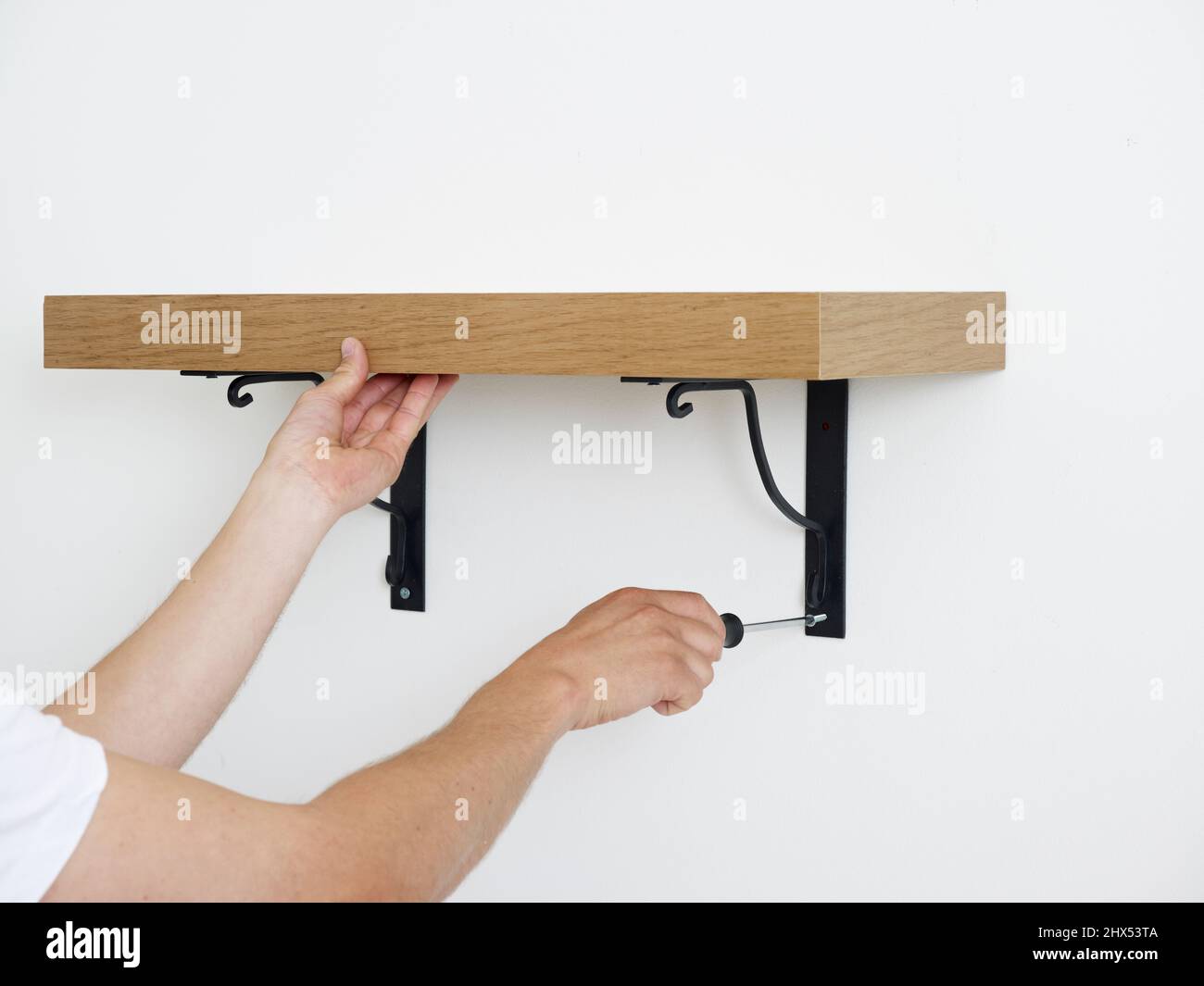 Fitting walls shelves, attaching the shelf to the wall using a