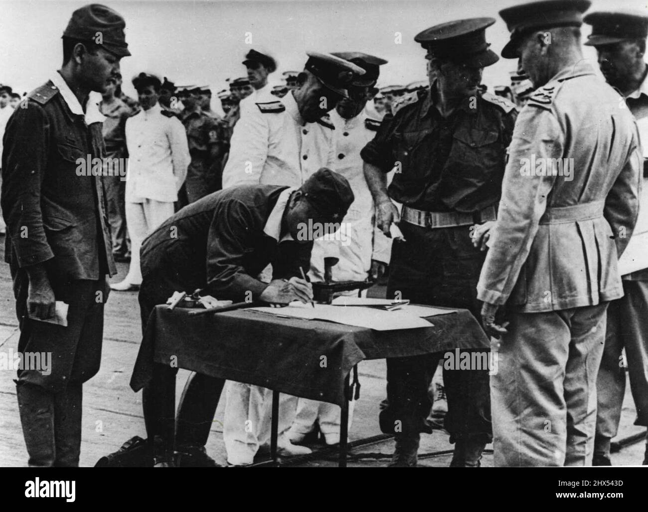 Japanese South-Eastern Army Chief Surrenders on Board H.M.S. Glory -- Picture taken on board the British light fleet carrier Glory off ***** on September 6 '45 when the surrender of the Japanese in the South-West Pacific area was signed by General Imamura, C. in C. of the Japanese south-eastern Army and by Admiral Jin Ieha Kusakaf for the Japanese south-eastern naval forces in the area.General ***** Signing the official document for the surrender of 139,000 Japs in New Britain, New Zealand, Solomone and New Guinea. The surrender ceremony took place on the flight deck of H.M.S. Glory Lieutenant Stock Photo