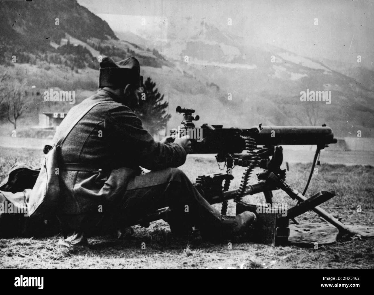 The Swiss Army Are Ready - A Machine gunner in position. Switzerland has joined the small neutrals in keeping strict watch on her Frontiers. Swiss Fortifications are being rapidly erected, and a large scale call-up has brought her Army in the field up to 200,000. April 28, 1940. (Photo by Sport & General Press Agency, Limited). Stock Photo