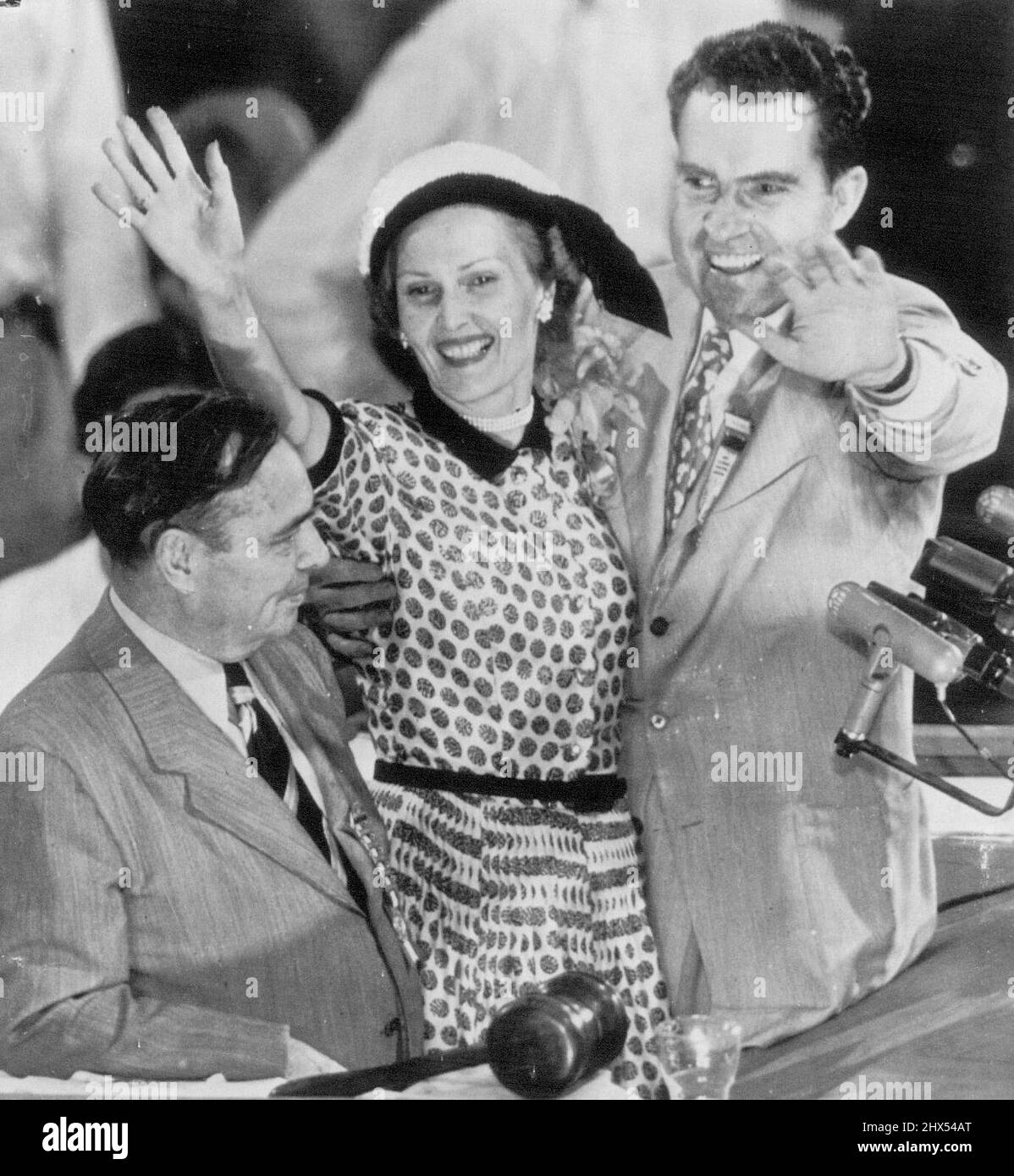 There's Joy On The Rostrum -- Sen. Richard Nixon and his wife wave to plaudits of delegates from speaker's podium after his selection to be Gen. Dwight D. Eisenhower's running mate on GOP presidential ticket. Nixon's selection as vice presidential candidate wan by acclamation. With them is Chairman Joseph Martin. July 11, 1952. (Photo by AP Wirephoto). Stock Photo