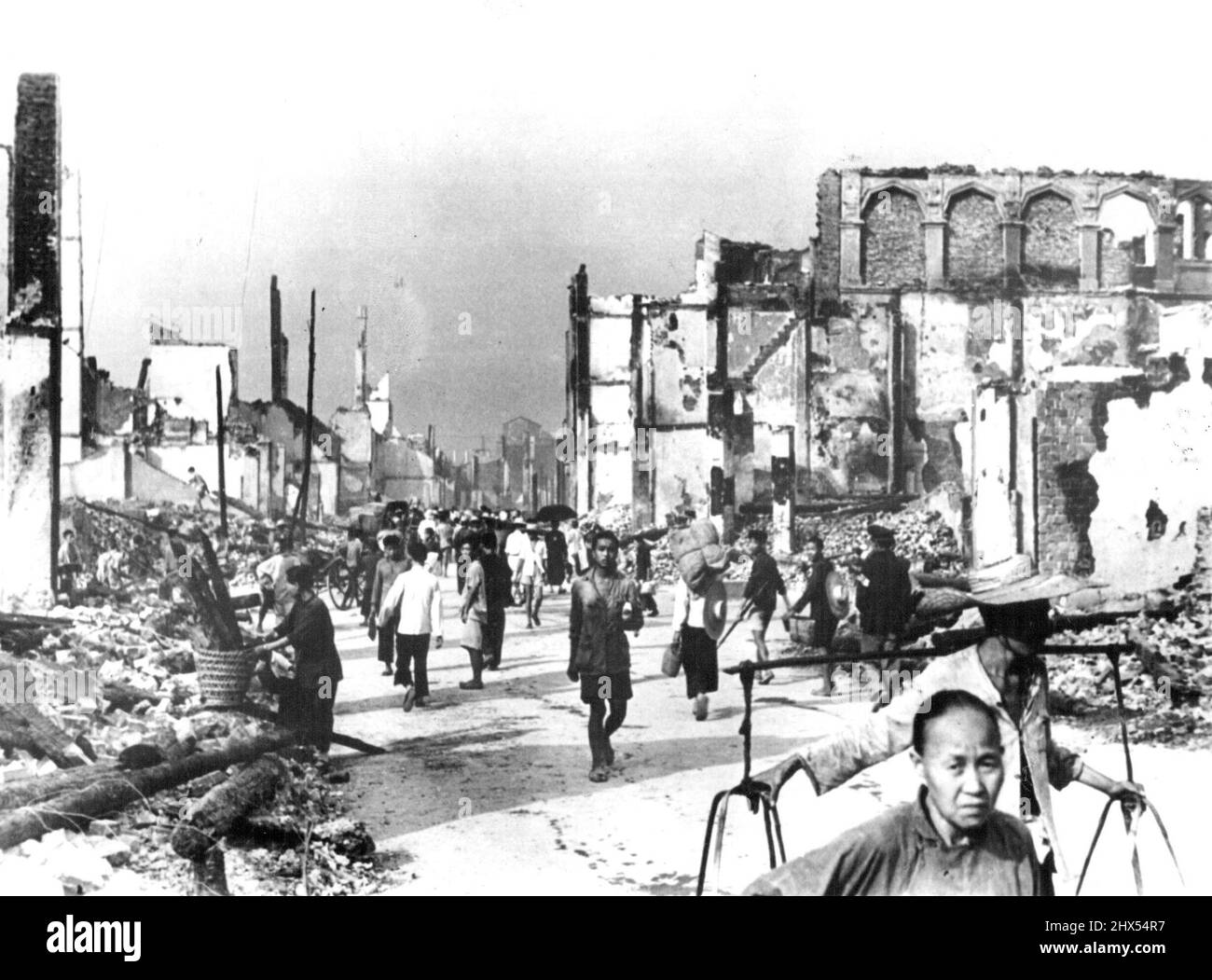 Life Goes On Amid Death. Less than one of five buildings in the Ancient and congested walled city area of Chungking was unscathed after three months of aerial bombardment of China's wartime Capital was Climaxed by a five day and night attack which ended Aug.23. Nothing but ruins may be seen in this picture, but Chinese Citizens Carry on, Seemingly unperturbed by it all. November 9, 1940. (Photo by Associated Press Photo). Stock Photo