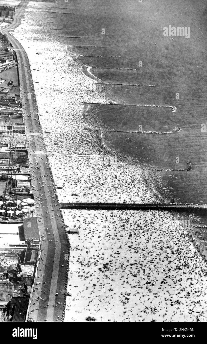 Mecca Of Melting Millions Plus -- A crowd estimated at more than one and one-half million persons by Police Capt. Walter Winterhalter, swarm on the Sandy Beach and in the surf in effort to escape fifth day of the heat wave which kept temperatures in the nineties, Aug. 29, in the New York Metropolitan Area. August 29, 1948. (Photo by Associated Press Photo). Stock Photo