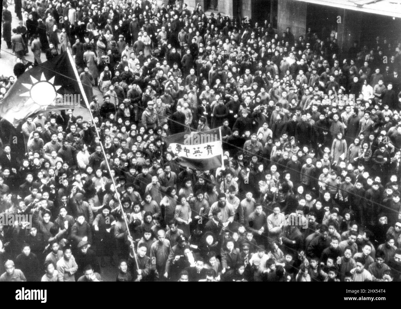Chinese Students Protest Against Soviet Troops In Manchuria - Waving a Chinese flag and carrying a banker, Chinese students gather in front of the Soviet consulate in Shanghai to agitate for removal of Soviet Troops from Manchuria. Some 2,500 persons took a part in the Demonstration, staged at the same time the consulate was celebrating the 28th anniversary of founding of Red Army. March 6, 1946. (Photo by AP Wirephoto). Stock Photo
