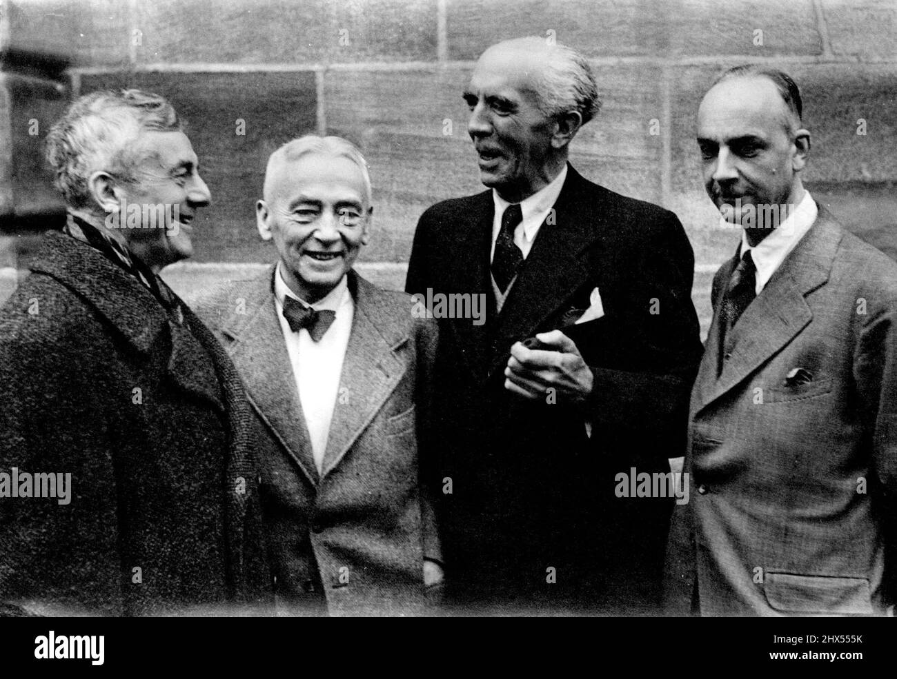 They Will Defend Leading German War Criminals -- The first picture of the German defence counsel who will defend the leading German war criminals to be placed on trial at Nuremburg next week Left to right are Dr. Hans Marx, defending Julius Streicher, the 'Jew Baiter'; Dr. Otto Stagier, defending Hermann Goering; Dr. Fritz Sauter, defending Joachim von Ribbentrop; and Dr. Gunther von Rohrscheidt defending Rudolf Hess - photographed outside the court at Nuremburg where the major war criminals will be tried. November 17, 1945. Stock Photo
