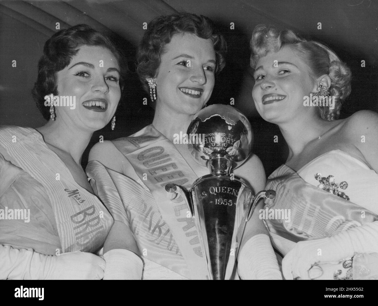 Congratulations for Miss Queensland (Maureen Kistle), centre, from runner-up Jan Kenny (left), a Brisbane finalist, and Glenys Wood, Miss South Coast regional winner, who was placed third in the final of the Queensland section of the Miss Australia Quest last night. November 2, 1955. Stock Photo