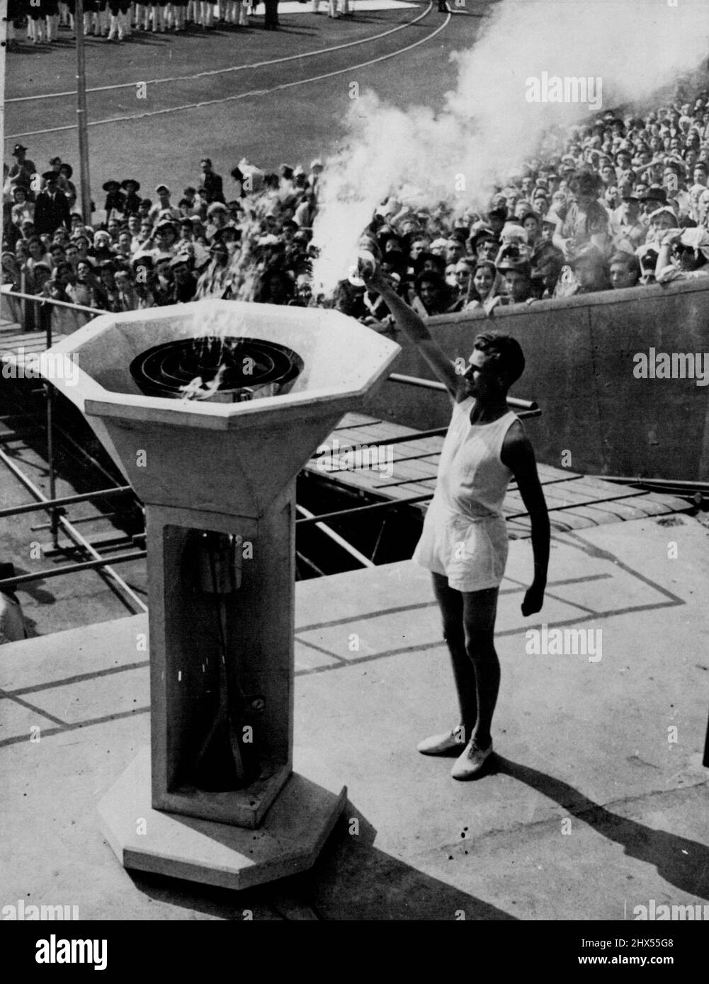 XIV Olympic Opens -- The mystery of the torchbearer who was to carry the final torch, ended when John Mark, a Cambridge Athletic blue arrived at the Wembley Stadim at 3.50 to perform the ceremony of lighting the Olympic Flame at the Opening of the 1948 Olympic Games. July 29, 1948. (Photo by Reuterphoto). Stock Photo