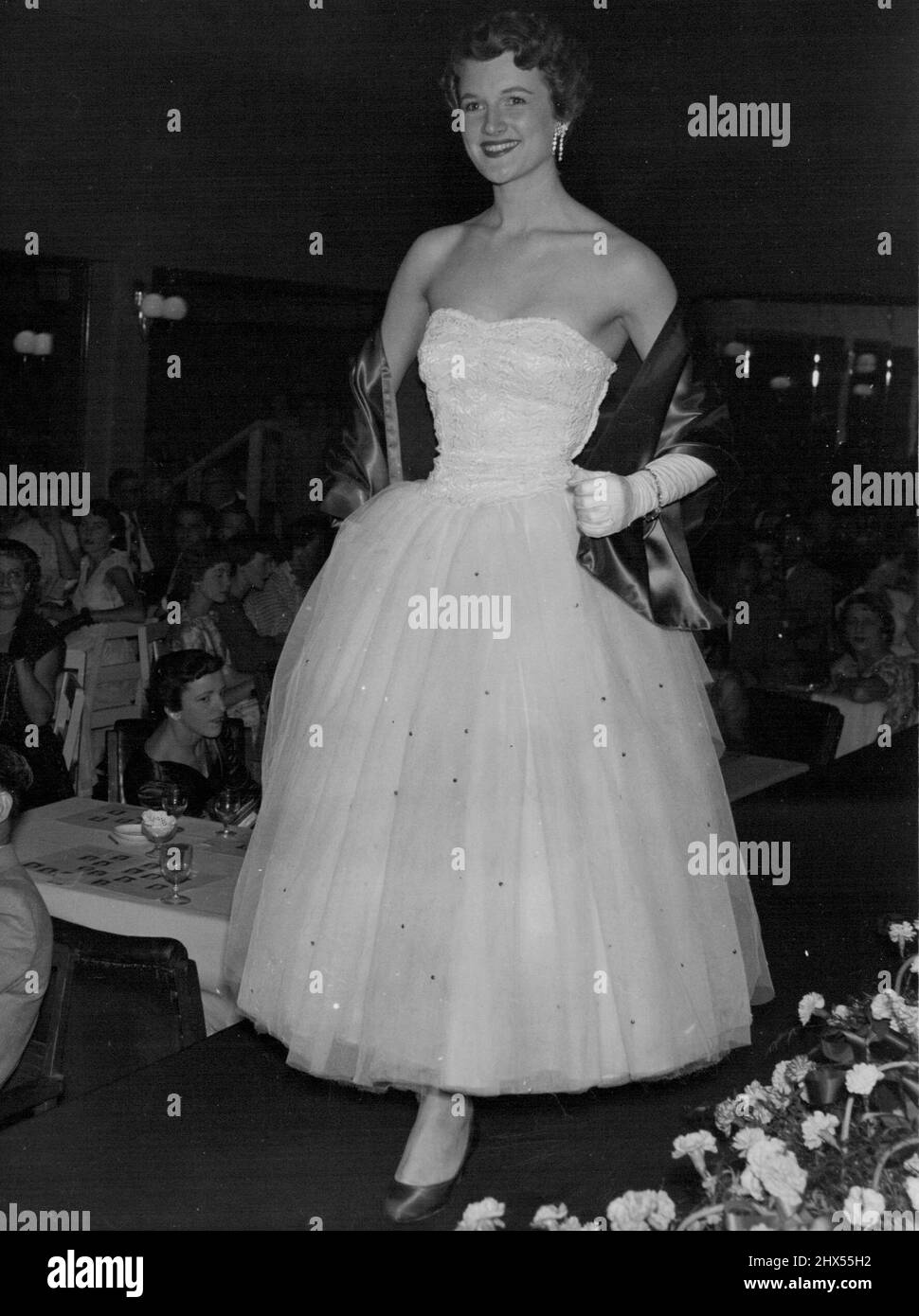 Maureen Kistle Miss ***** Queensland, in her ***** length gown of ***** white tulle and guipure *****, and emerald green stole shoes. November 2, 1955. Stock Photo