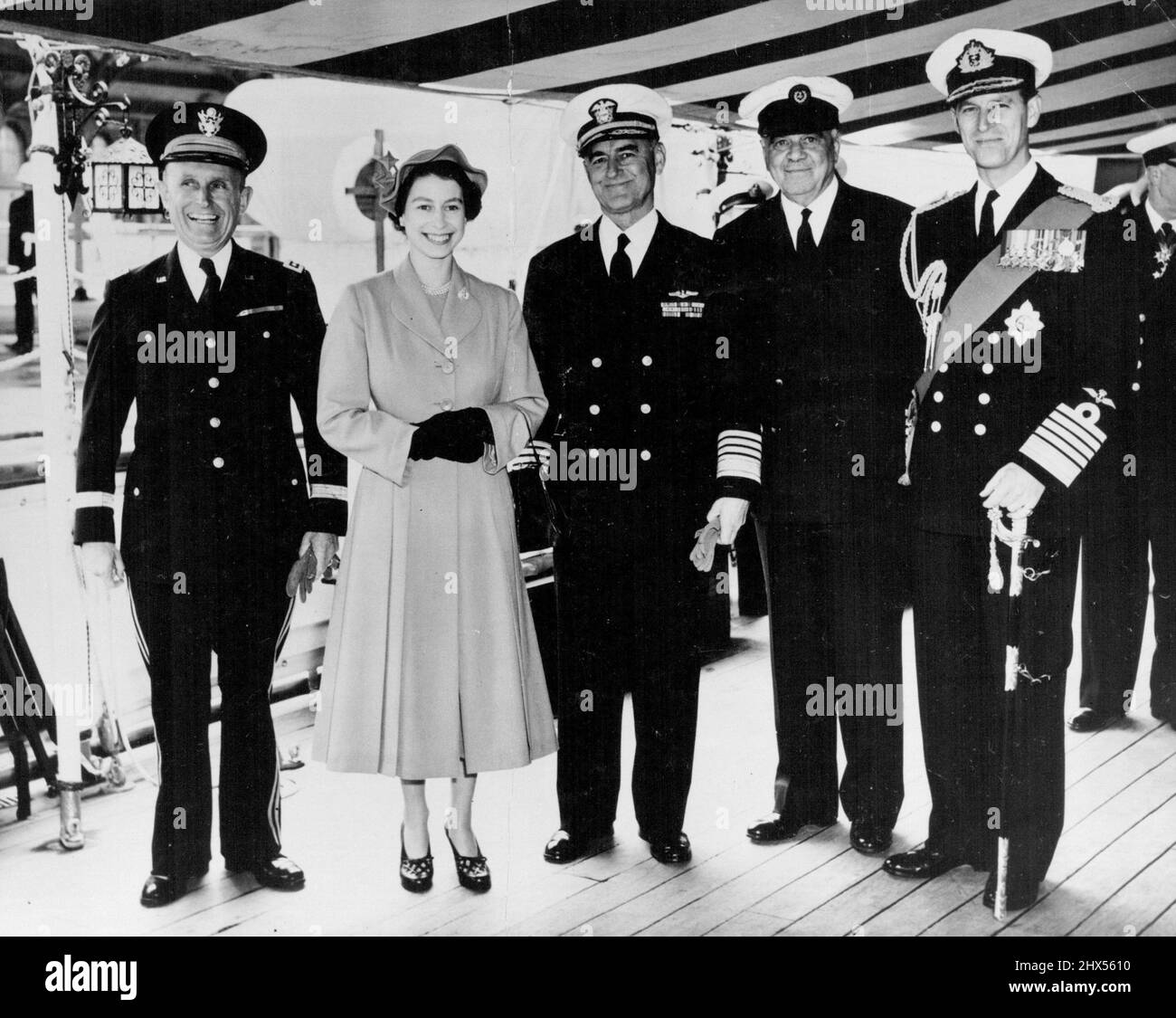 The Queen Receives High Ranking Naval Officers Aboard The Royal Yacht -- A happy group aboard H. M. S. surprise comprising (left to right) Lt. Gen A. Gruenther (Chief of Staff of S.H.A.P.E. ); H.M. The Queen; Admiral Lynde McCormick (Supreme Allied Commander, Atlantic); Lord Ismay (Secretary General N.A.T.O) and H.R.H. The Duke of Edinburgh.H.M. The Queen between decks on the Royal Yacht Surprise) received the first Lord of the Admiralty, Mr. J. P. L. Thomas, who presented to her and the Duke of Edinburgh, the members of the Board of Admiralty, Lord Ismay, Secretary General of N.A.T.O., the Su Stock Photo