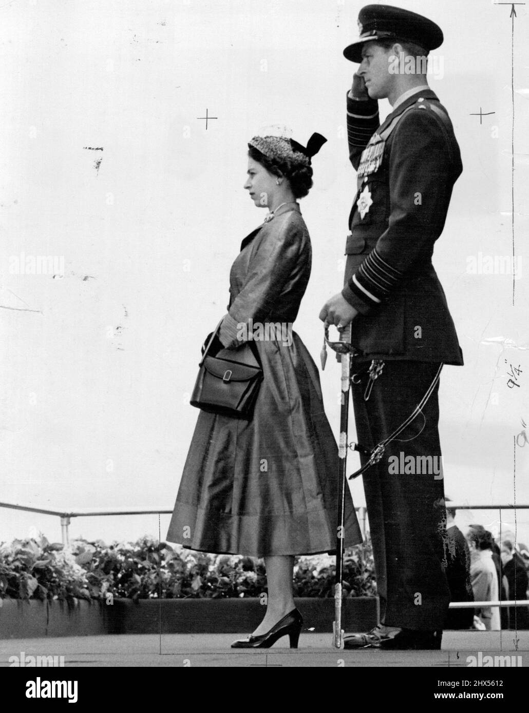 The Queen and Prince Philip photographed during the Royal Air Force Review held at Odiham, Hants, today. The Queen photographed watching a Royal Air Force Review wearing a waisted coat in stiff shantung. It's a gay little straw hat with a perky, stiffened velvet bow. July 15, 1953. (Photo by Daily Mirror). Stock Photo