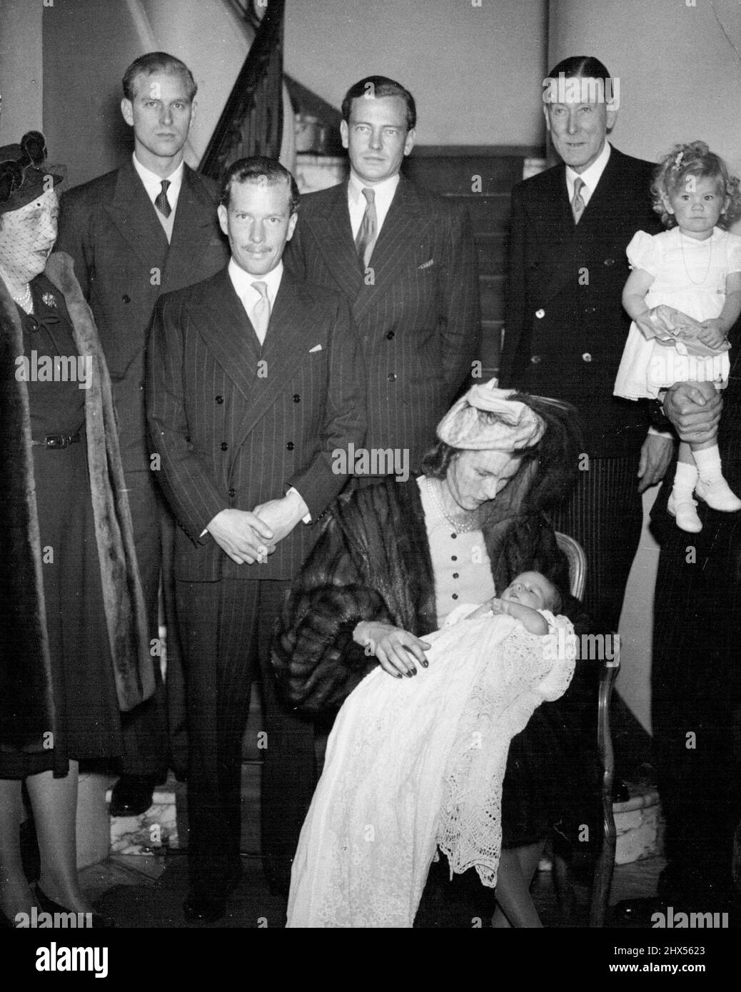 Lt. Mountbatten God-Parent At ChristeningPicture at Lt. -Col. Philips' home in Grosvenor-square, London, today, following the christening ceremony are (left to right standing) Lady Zia Wernher, Lieut. Philip Mountbatten, Major D. Butters the Marquess of Milford Haven Colonel, H. Phillips, grand-father of the baby, and Sacha, daughter of Lt. -Col. and Mrs. Harold Phillips Mrs. Harold Phillips with her son Harold Nicholas, is seated in centre.Lieut. Philips Mountbatten R.N., and his fubure best-man the Marquess of Milford Haven, were god-parents at the christening ceremony of Harold Nicholas, ba Stock Photo