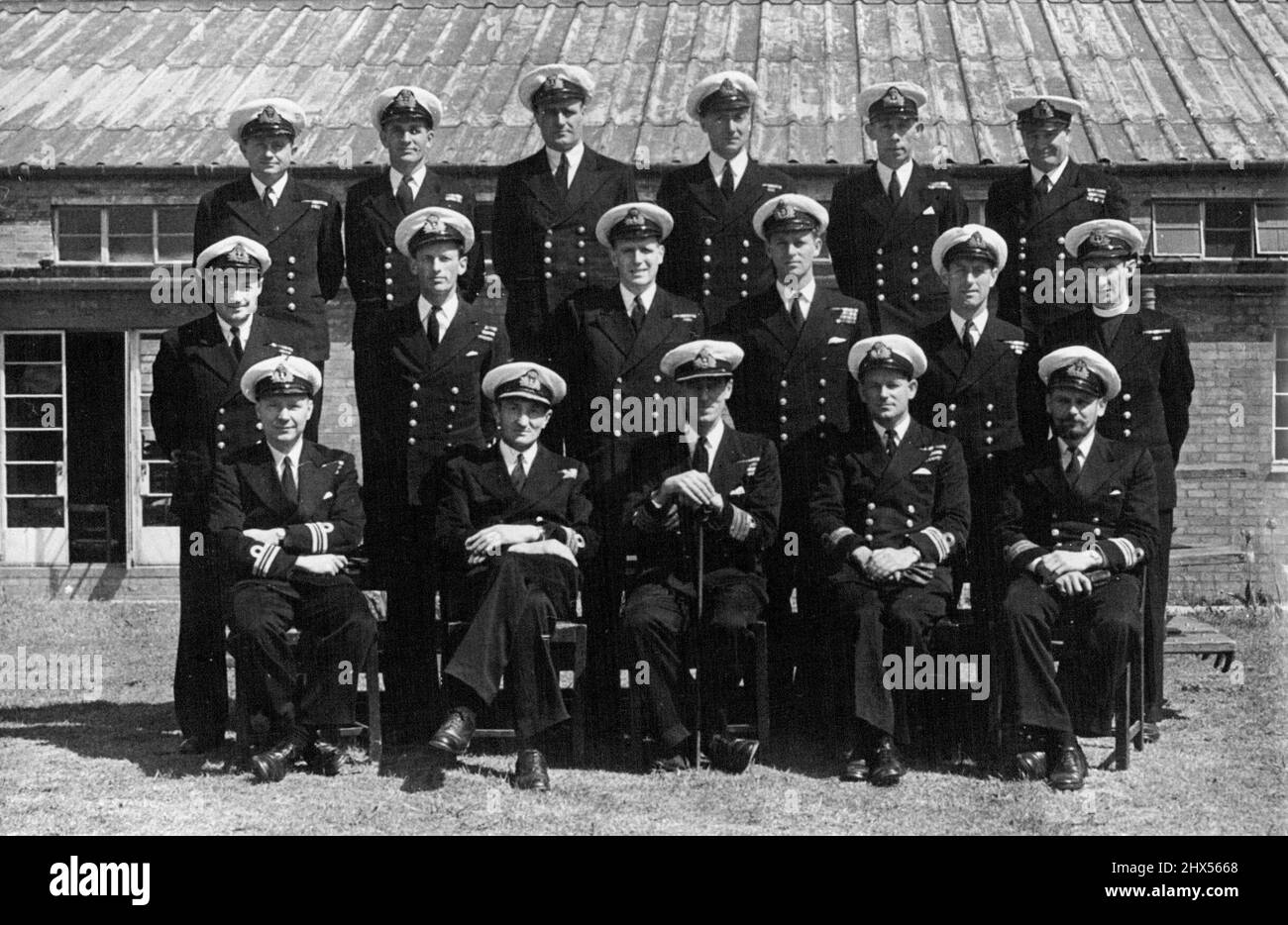 Lt. Mount Batten At P.O.'s School -- Lieut. Philip Mountbatten, R.N., Pictured with fellow officers at the Royal Naval Petty Officers' School, Kingsmoor, Corsham, Wilts.Front Row, left to right: Lieut Cdr. J.C. Ogle, DSC, Cdr. A.D.H.Jay, DSO, DSC & Bar; Captain H.W.Biggs, DSD & Bar, Lt. Cdr. R.G. Jennins, OBE, DSC, Lieut. Cdr. P.J.Hoare.Second Row, Left to right; Lt. Cdr. P.R.G.Worth, DSC, Lt.Cdr.W.D.O'Brien, DSC, Inst.Lt .K.R.G. Suckling, LT. Philip Mountbatten, Lt. E.G.Mason, Rev. B.N. Kennedy.Third Row, left to right: Lt. (E) A.L. Green, Mr. A.G.Samuel, (Cd.Gnr), Mr.E. Wheldrake (Cd.Bosun), Stock Photo