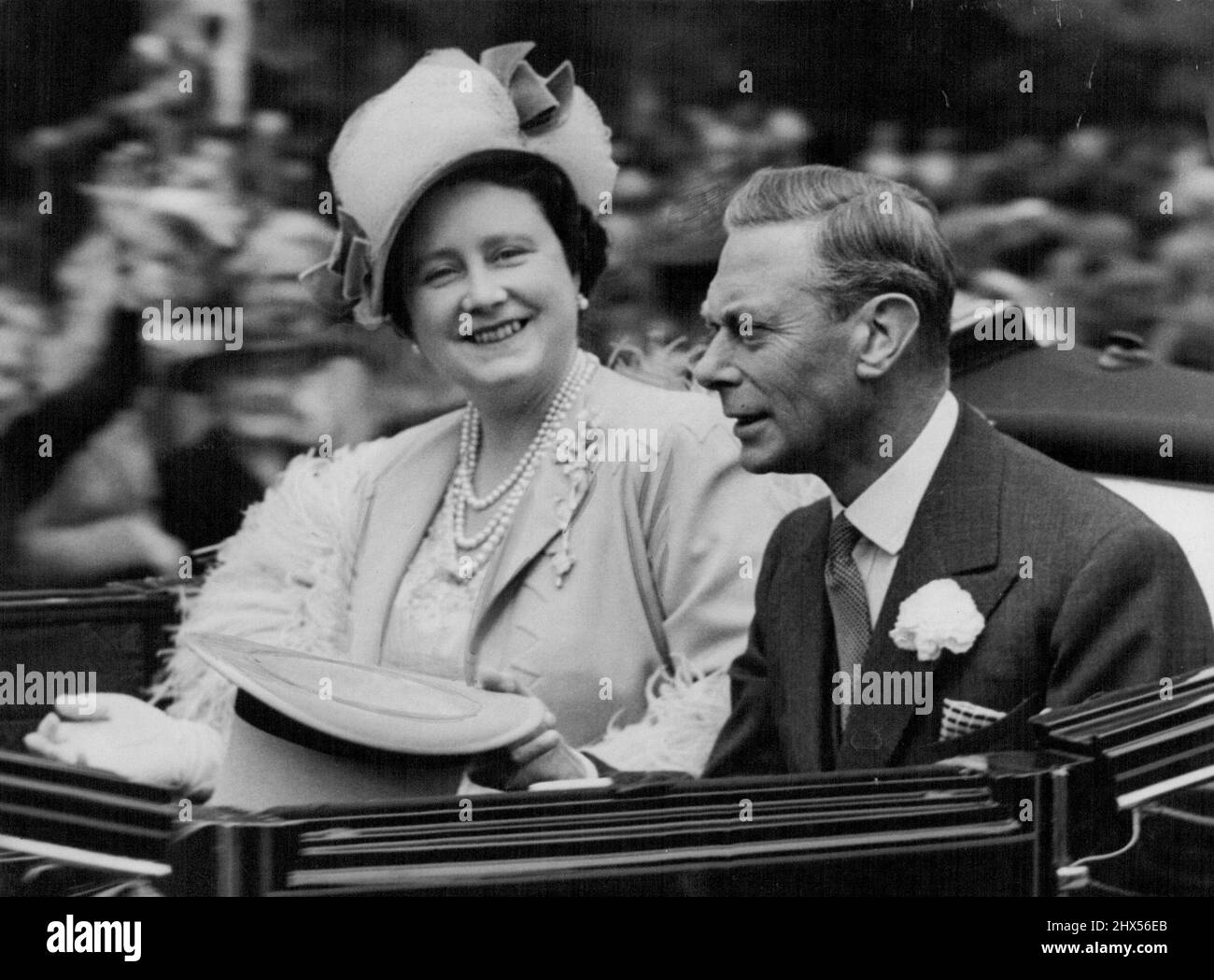 King and Queen At Ascot -- Their Majesties the King and Queen pictured in the leading carriage of the royal procession which was the traditional prelude to the second day of the Royal Ascot Meeting on the Famous Berkshire Racecourse Today, June 16. June 29, 1948. (Photo by Associated Press Photo) Stock Photo